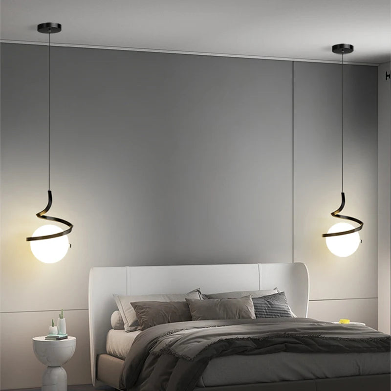 Modern black spiral pendant lights with white globe shades hanging over grey bedroom - contemporary ceiling lighting