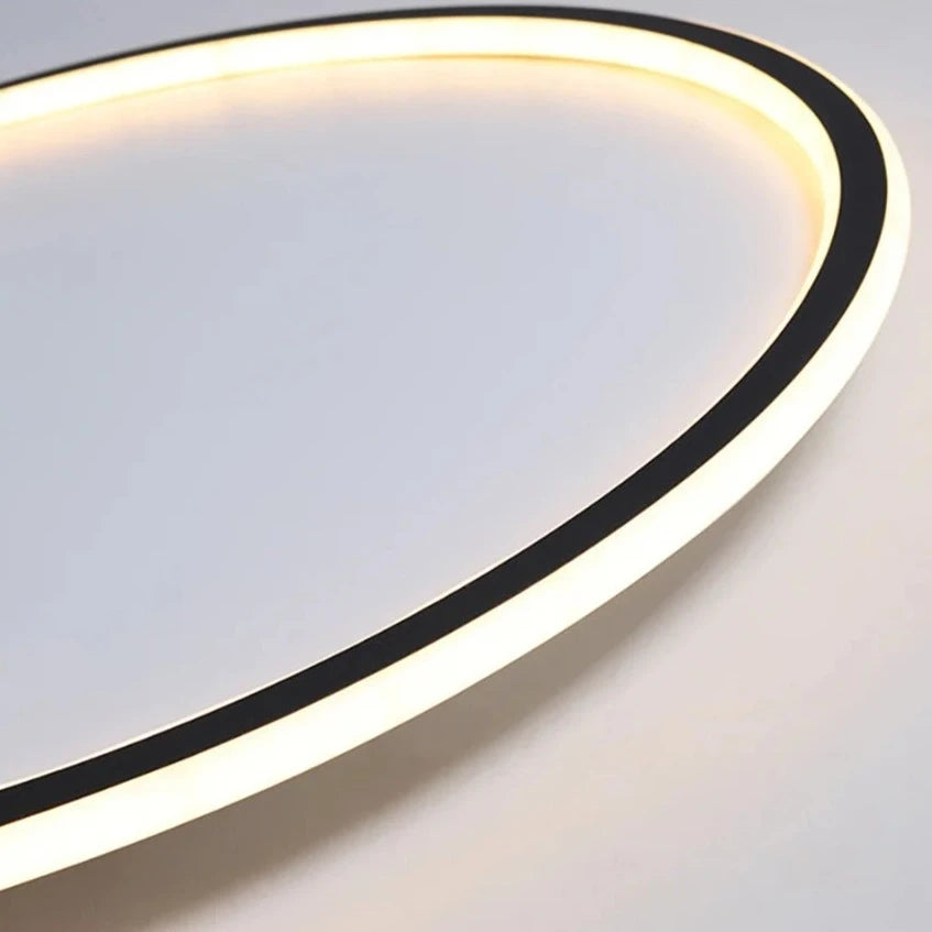 Close-up of a sleek LED ring ceiling light with a modern black and white frame