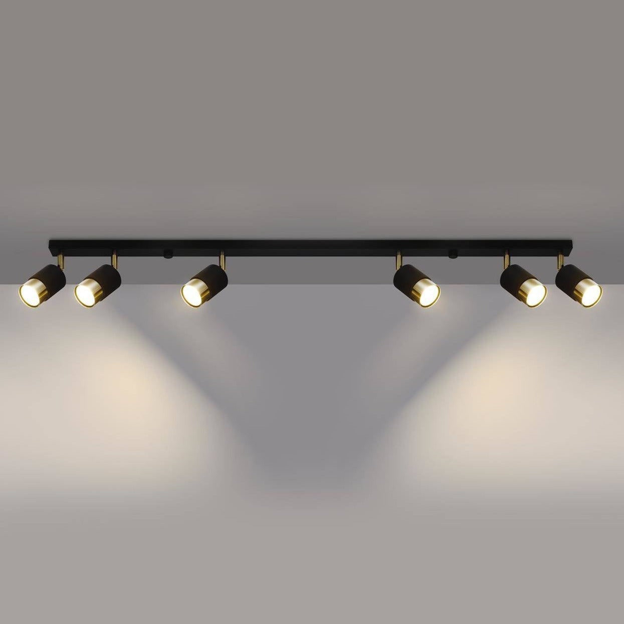 Six-light Trip Track Light in gold and black, providing adjustable focused lighting, ideal for ceiling or wall installation in various spaces