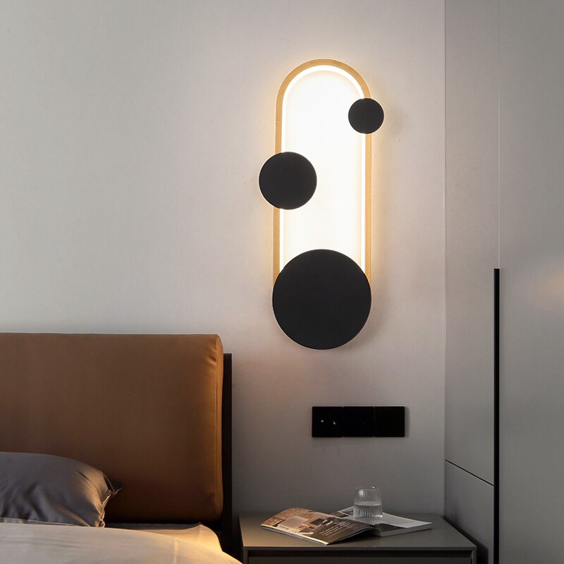 Oval Gold Dreake Modern Wall Sconce Light placed nearside bed