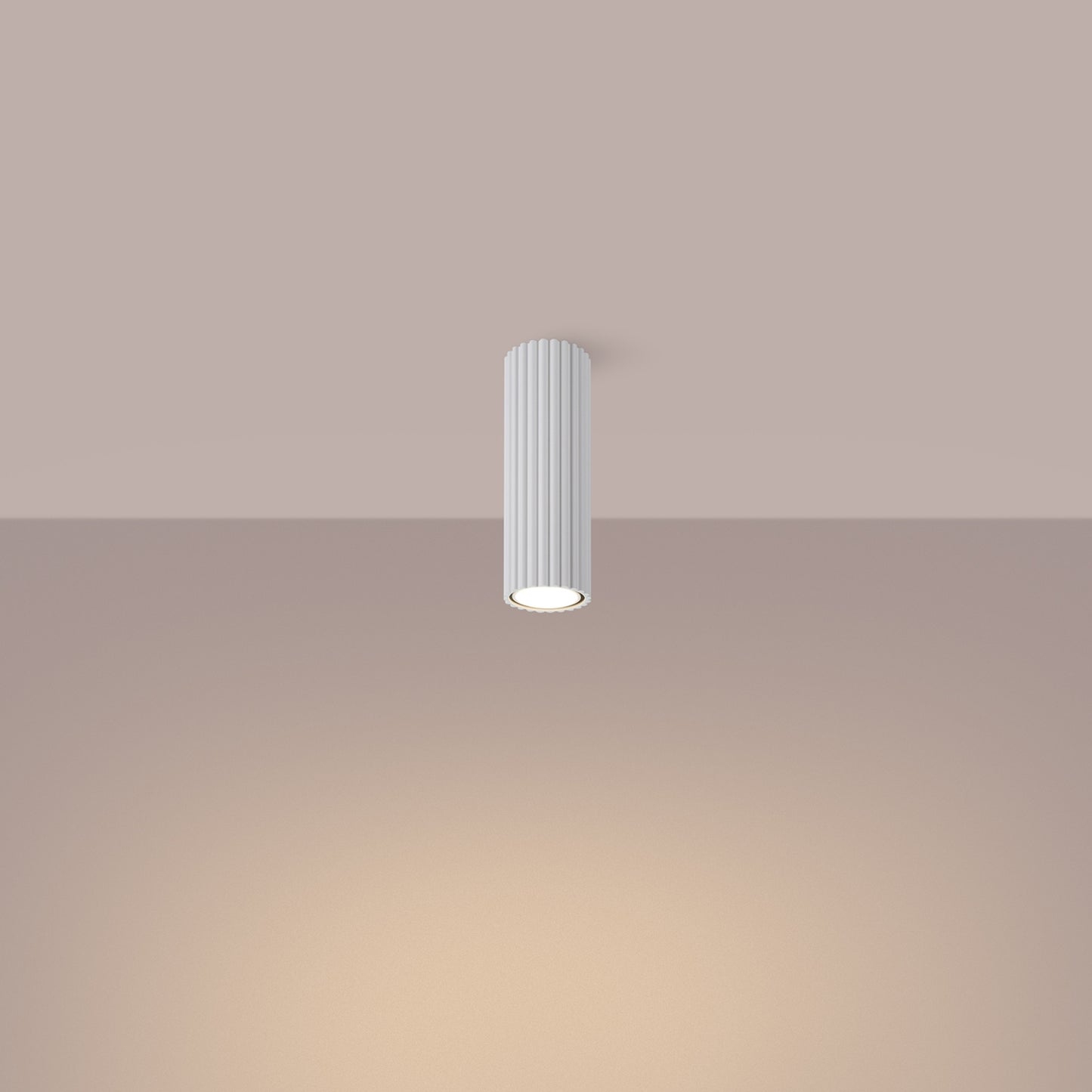 White Ribbed Tube Ceiling Spotlight 20cm switched on in modern UK home interior, warm LED glow