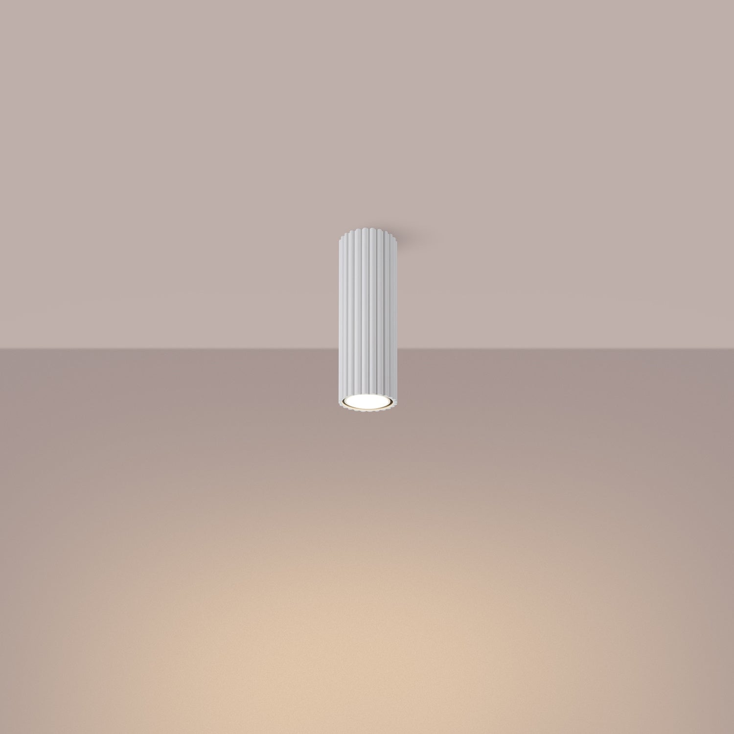 White Ribbed Tube Ceiling Spotlight 20cm switched on in modern UK home interior, warm LED glow