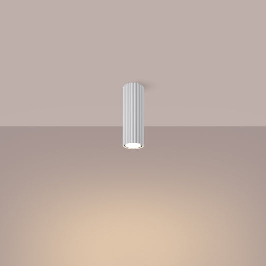 White Ribbed Tube Ceiling Spotlight 20cm switched on in modern UK home interior, warm LED glow