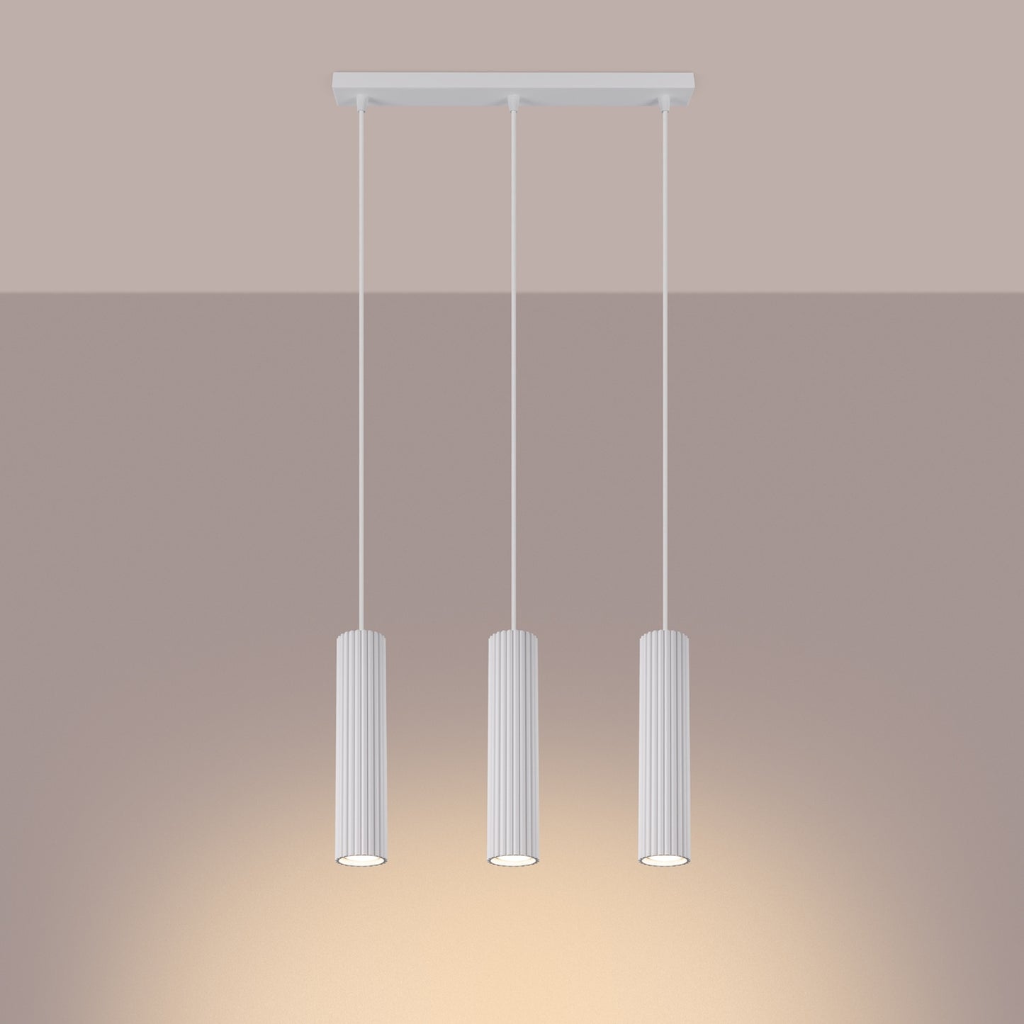 White Triple Ribbed Pendant Bar switched on in modern UK home interior, warm LED glow