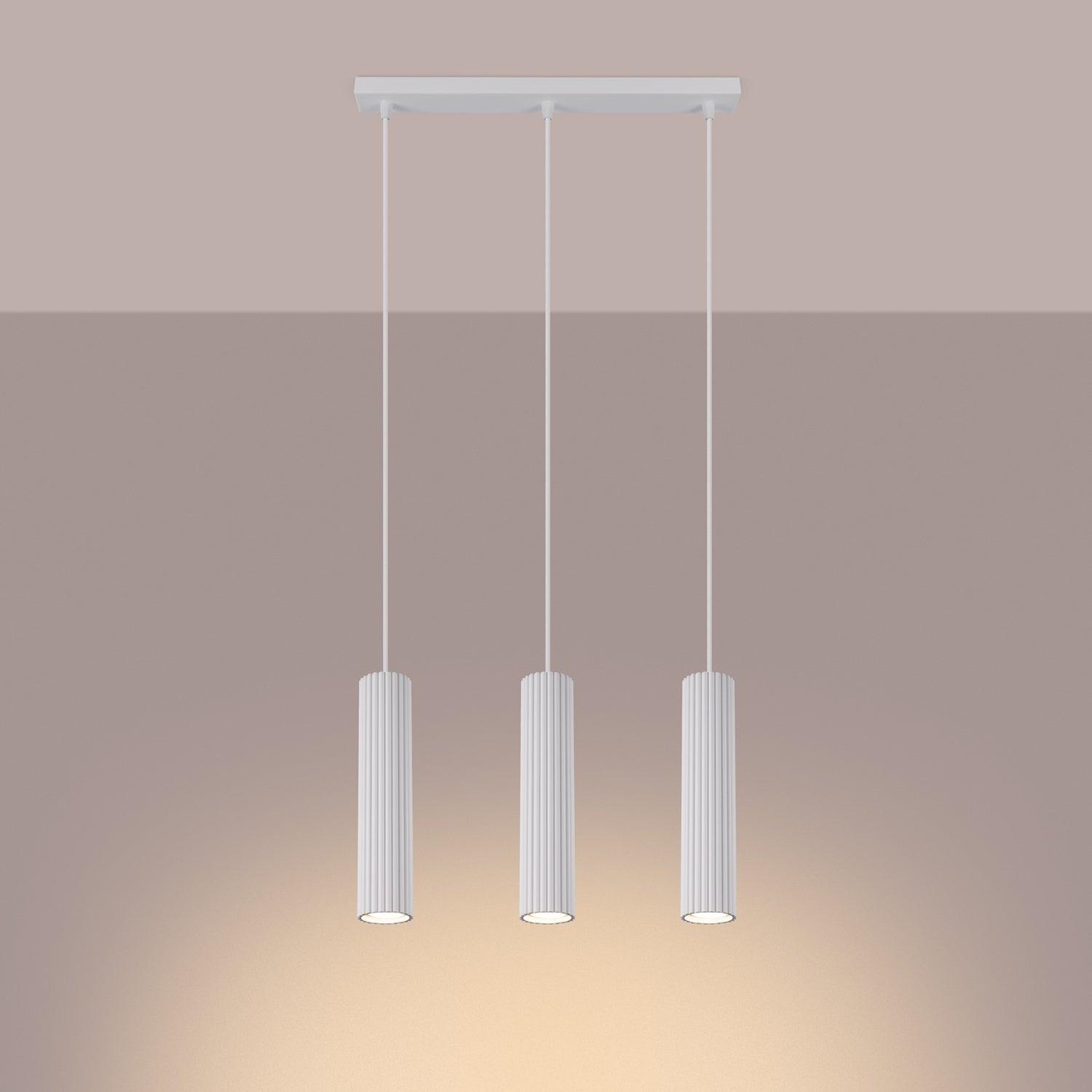 White Triple Ribbed Pendant Bar switched on in modern UK home interior, warm LED glow