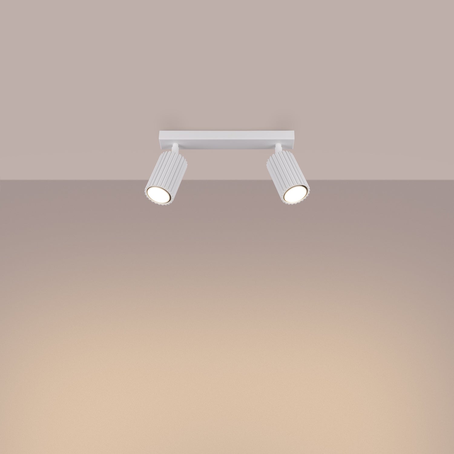 White Twin Ribbed Surface Spotlight switched on in modern UK home interior, warm LED glow