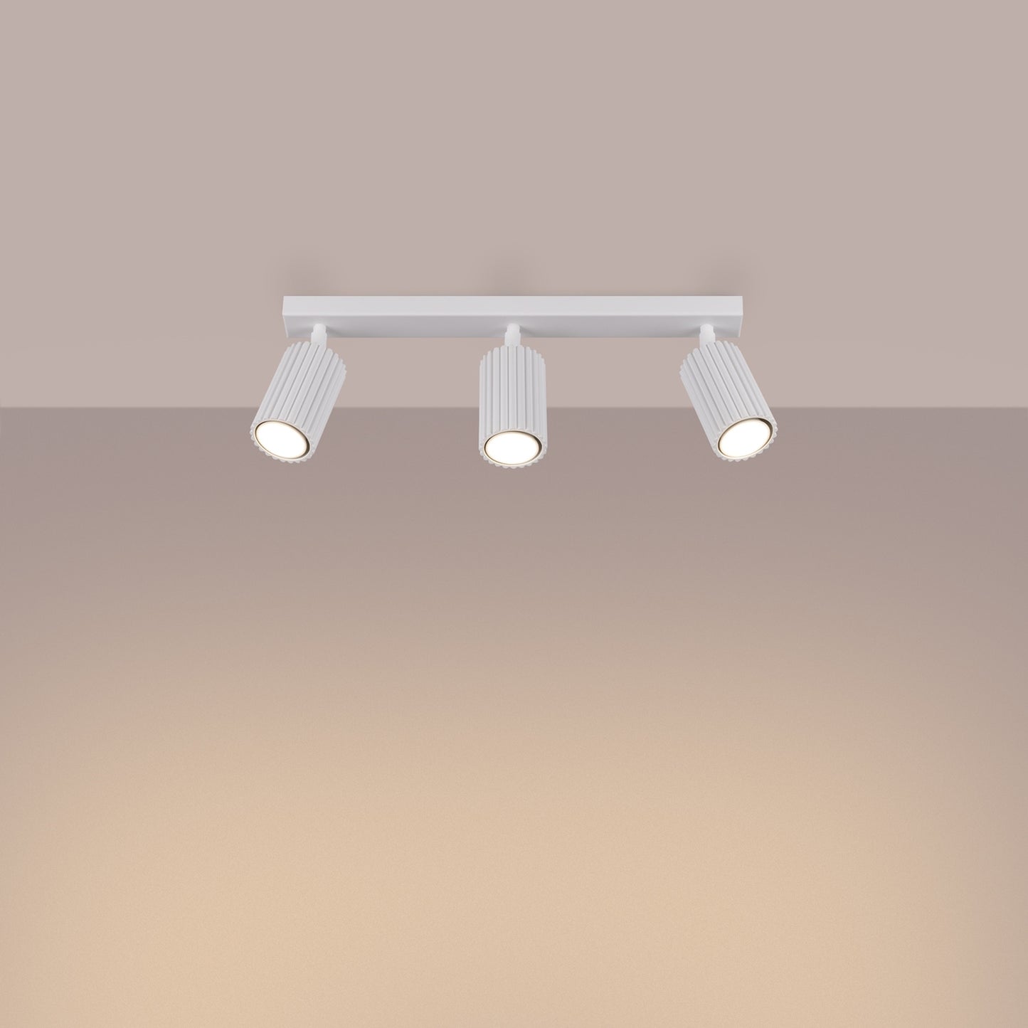 White Triple Ribbed Spotlight Bar switched on in modern UK home interior, warm LED glow