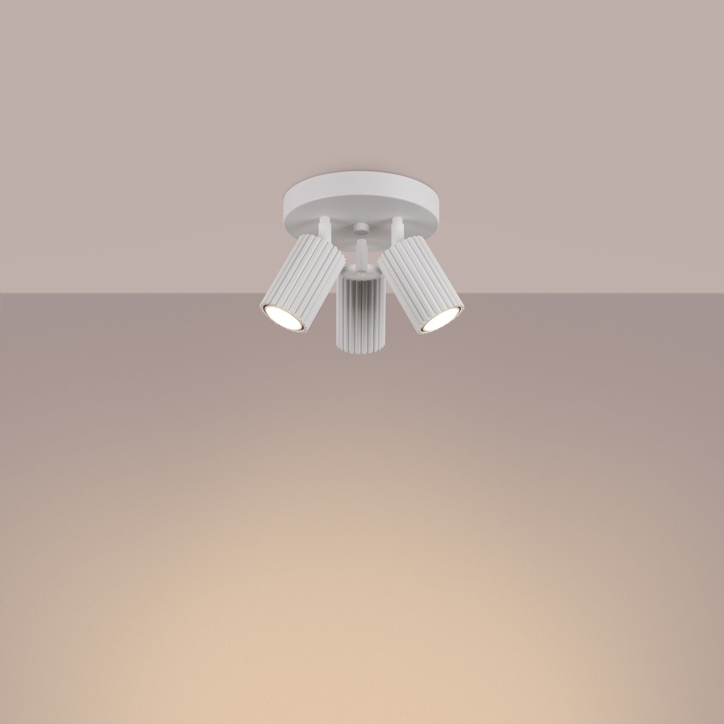 White Triple Ribbed Spotlight Cluster switched on in modern UK home interior, warm LED glow