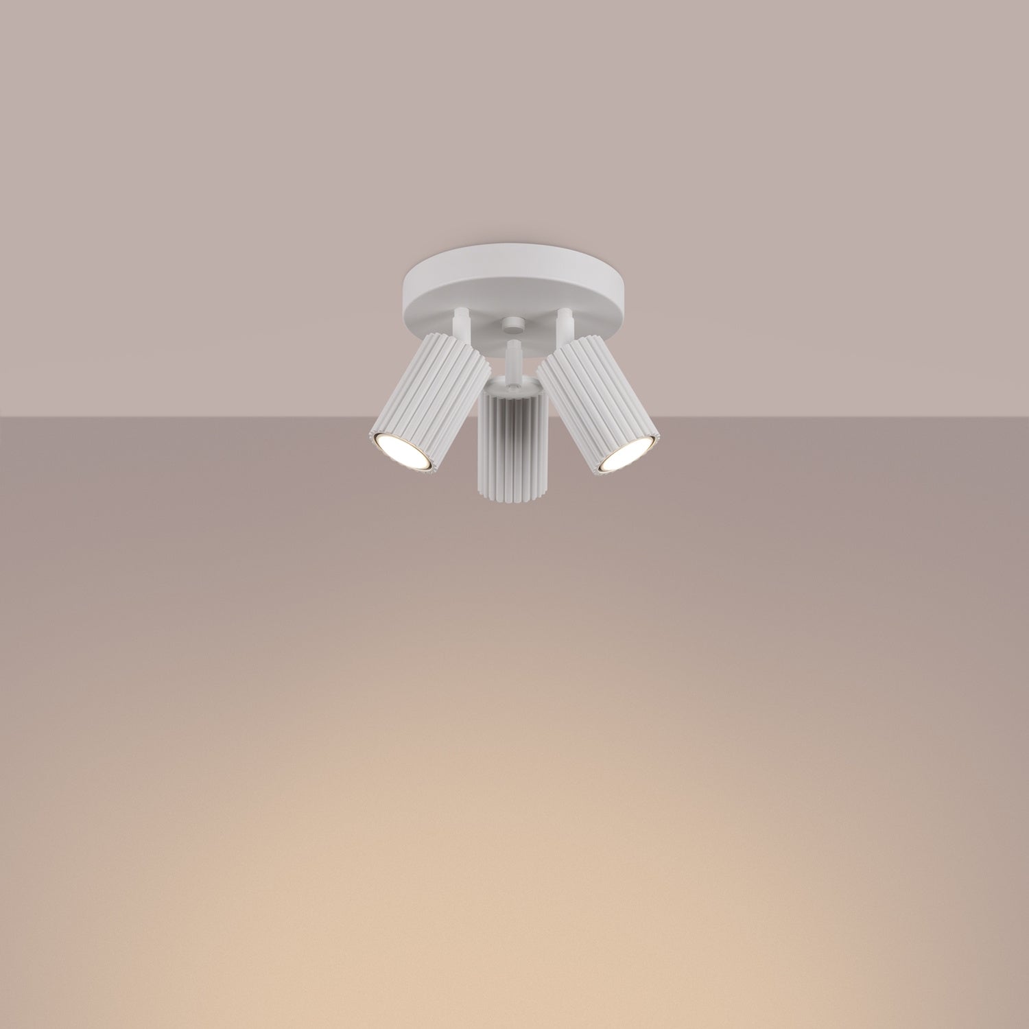 White Triple Ribbed Spotlight Cluster switched on in modern UK home interior, warm LED glow