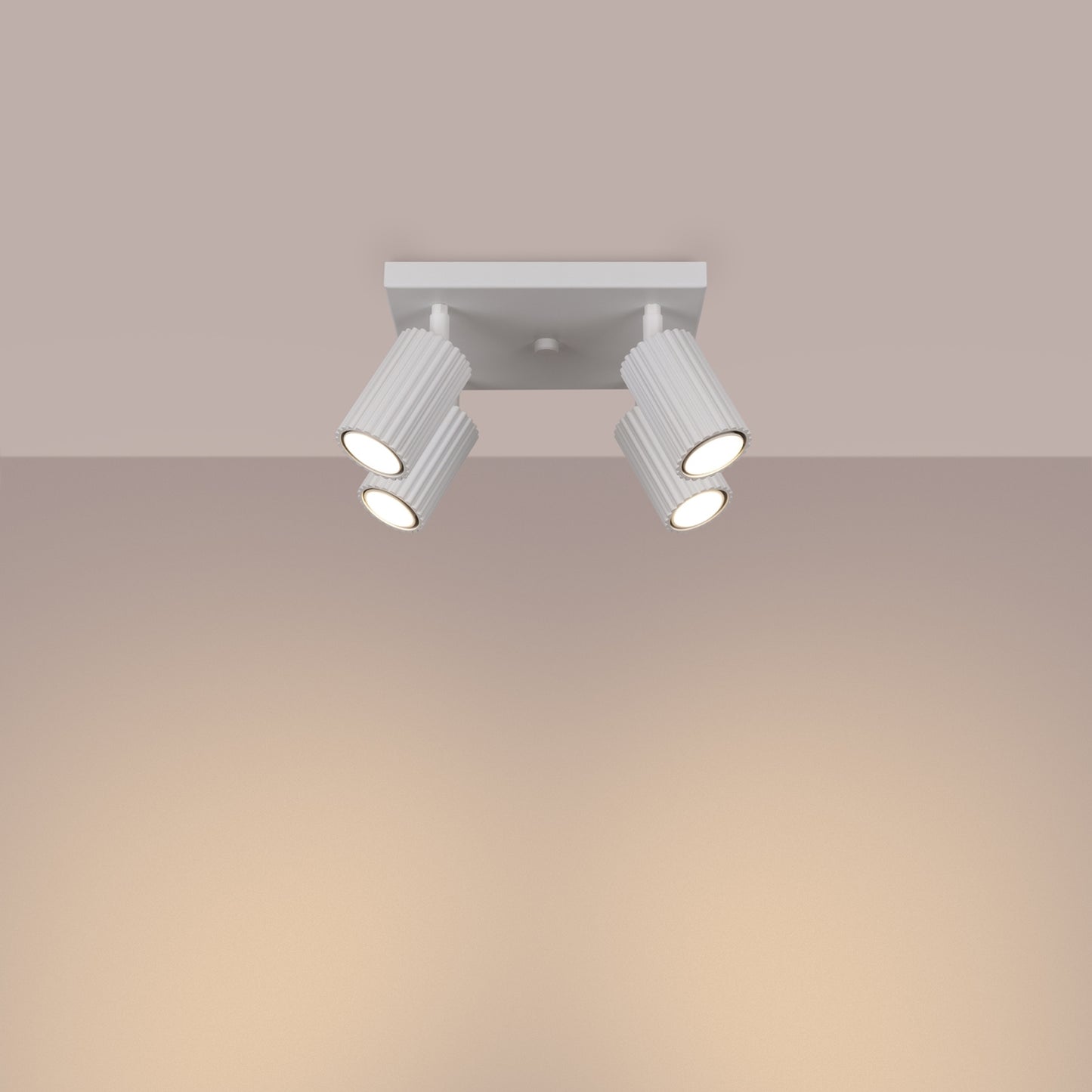 White Quad Ribbed Spotlight Cluster switched on in modern UK home interior, warm LED glow