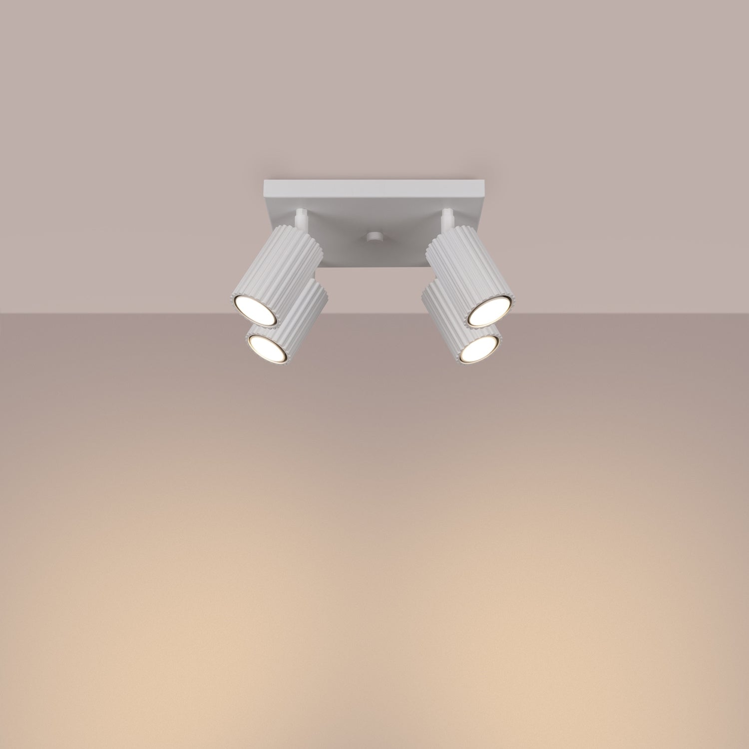 White Quad Ribbed Spotlight Cluster switched on in modern UK home interior, warm LED glow