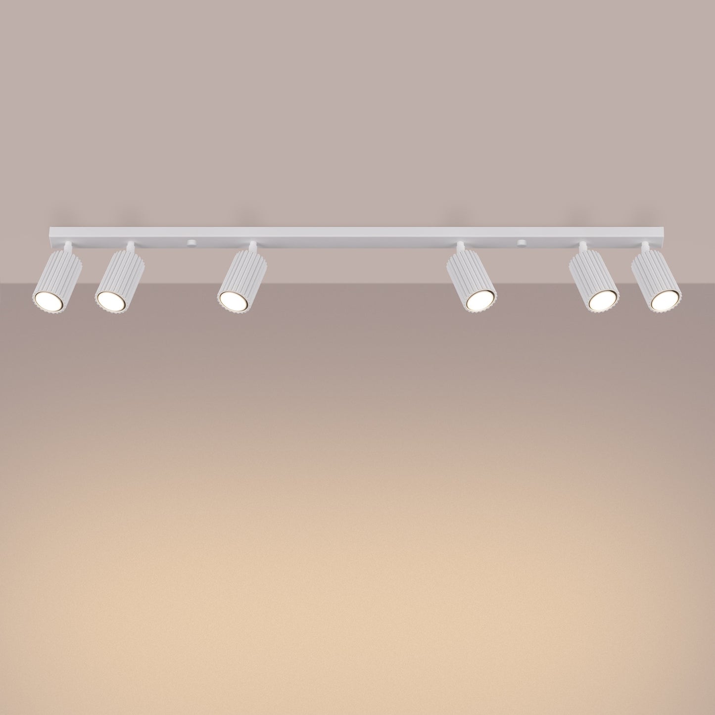 White Six Light Ribbed Spotlight Bar switched on in modern UK home interior, warm LED glow