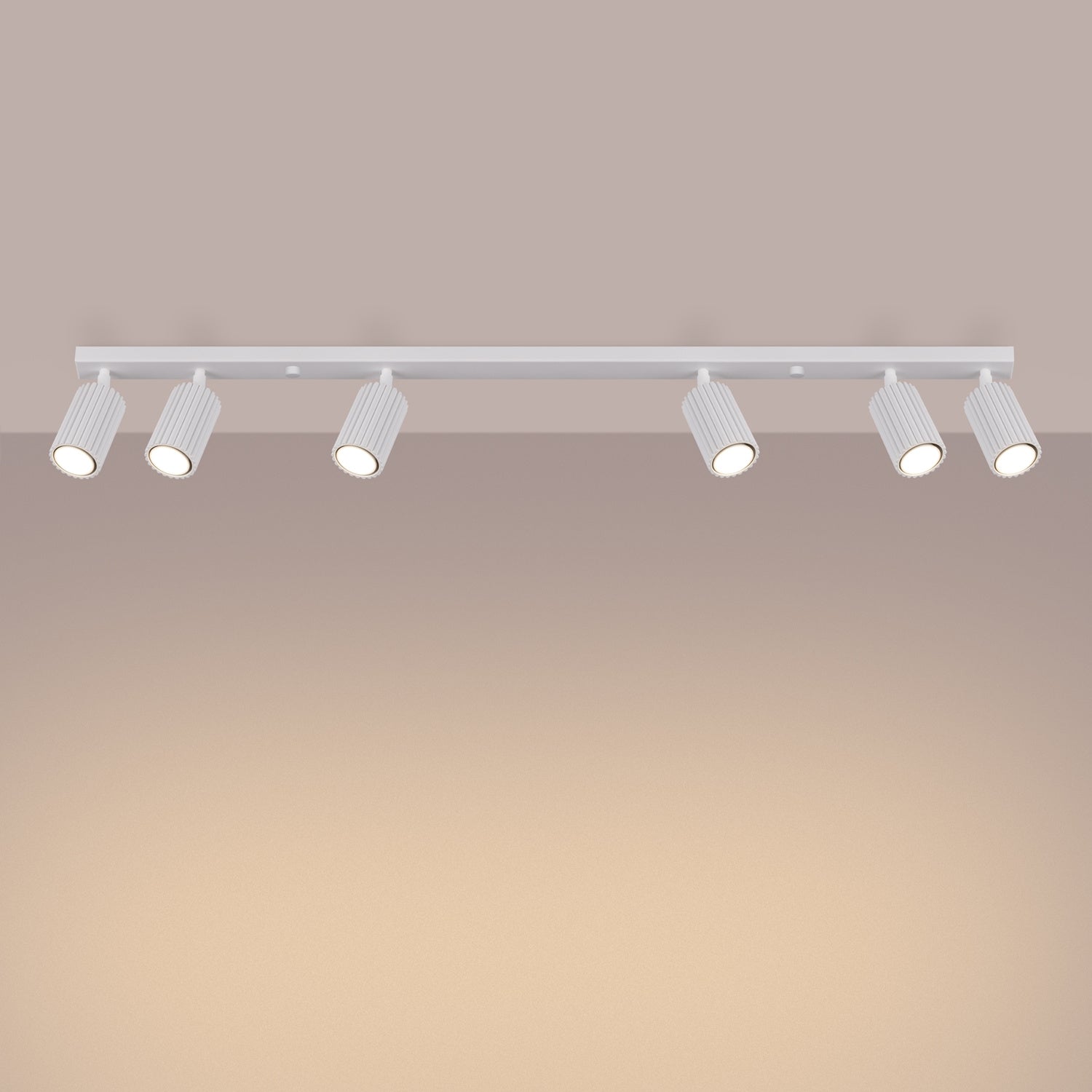 White Six Light Ribbed Spotlight Bar switched on in modern UK home interior, warm LED glow