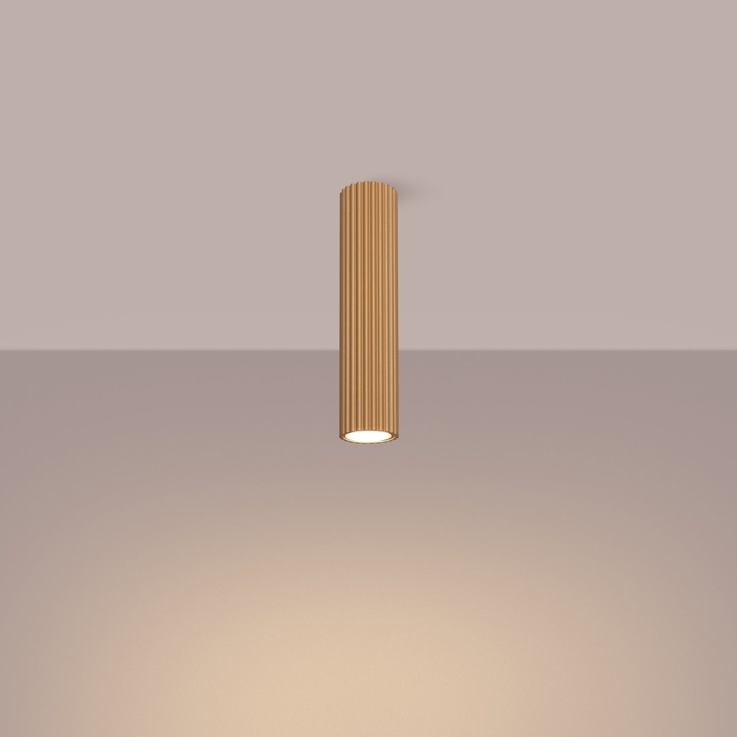 Gold Tall Ribbed Cylinder Ceiling Spotlight switched on in modern UK home interior, warm LED glow