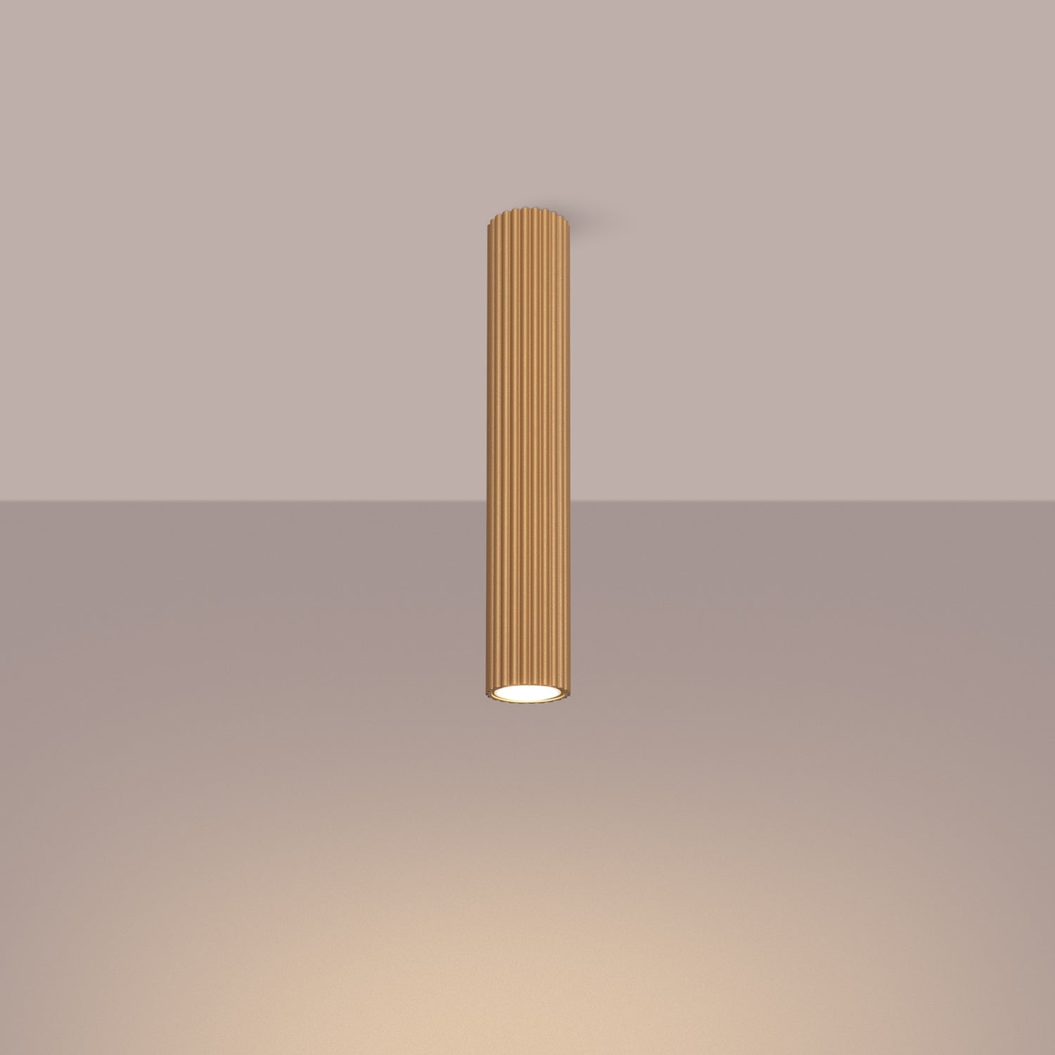 Gold Extra Tall Ribbed Cylinder Ceiling Light switched on in modern UK home interior, warm LED glow