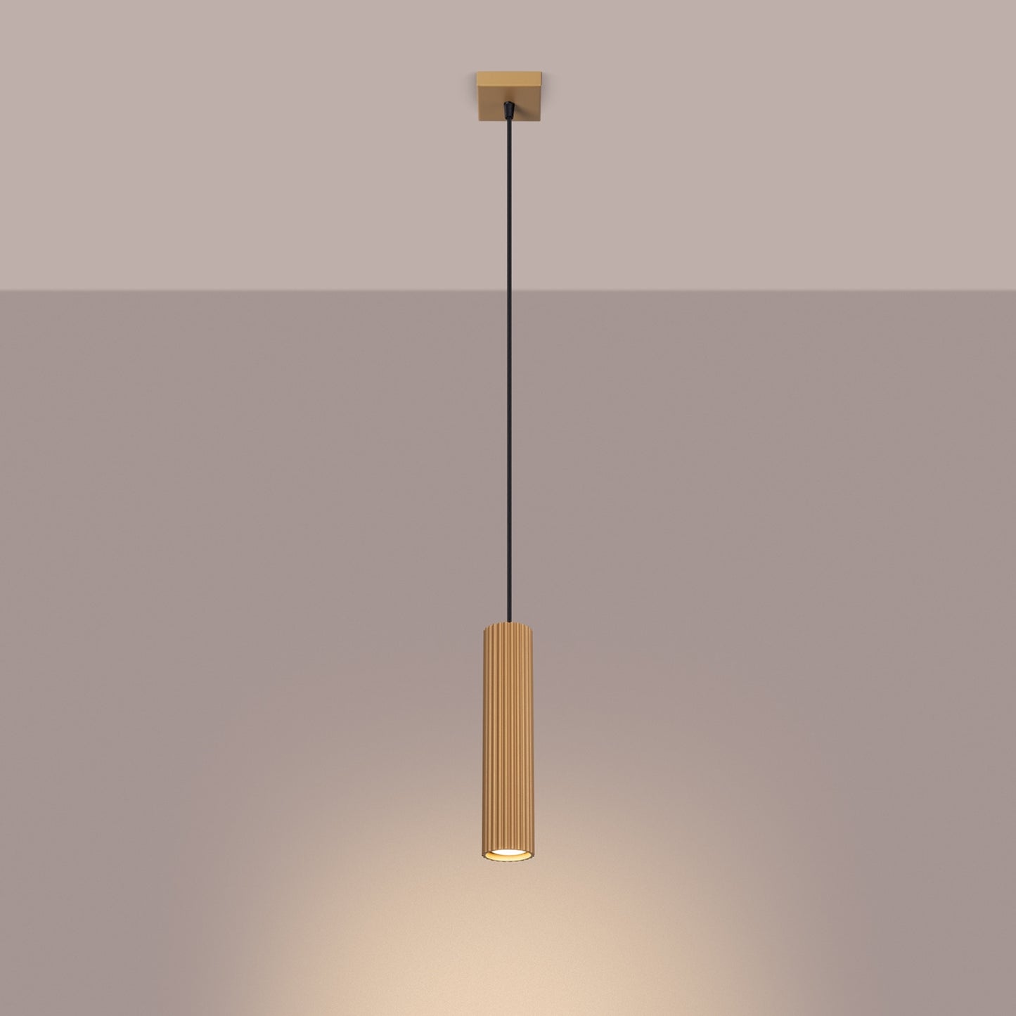 Gold Ribbed Cylinder Pendant Light switched on in modern UK home interior, warm LED glow
