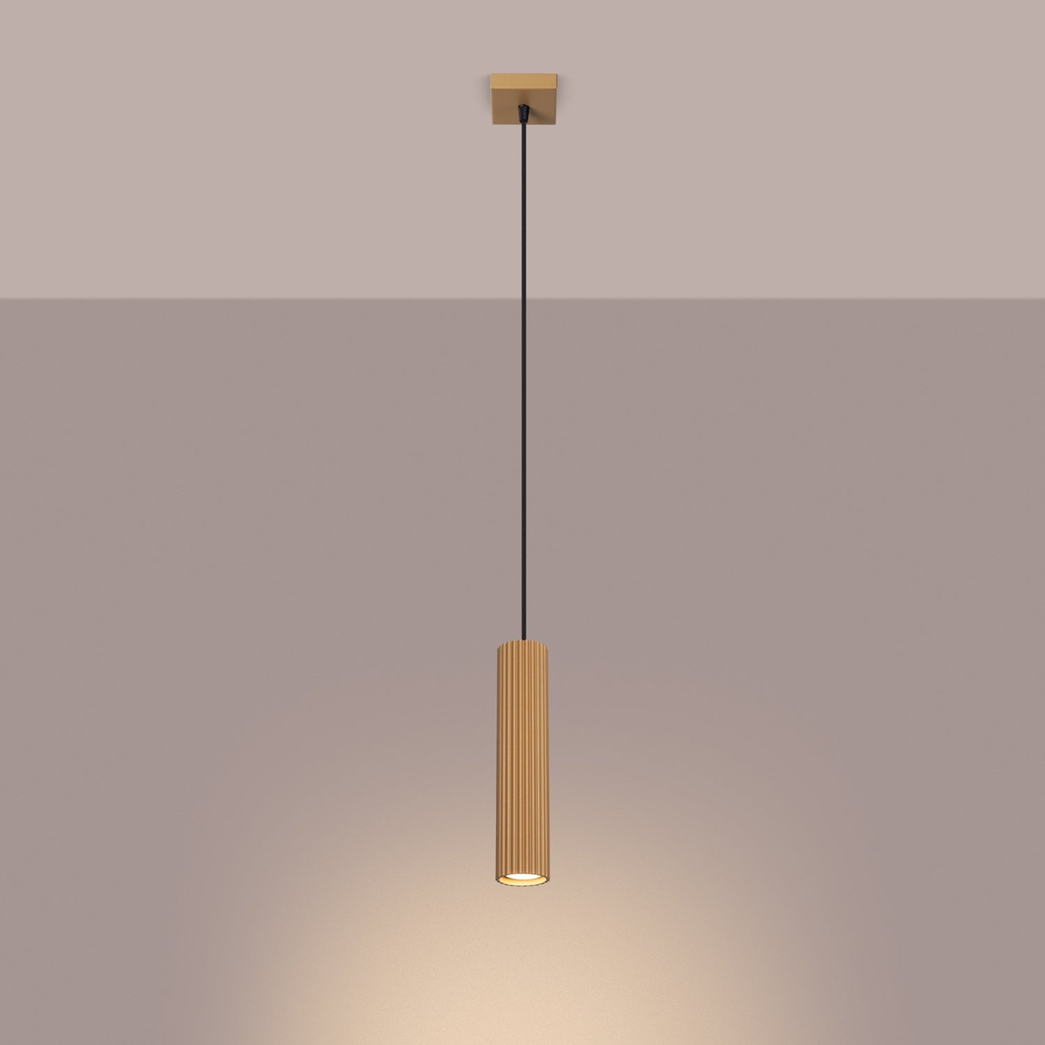 Gold Ribbed Cylinder Pendant Light switched on in modern UK home interior, warm LED glow
