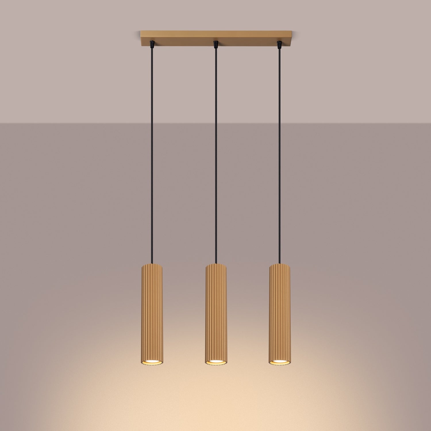 Gold Triple Ribbed Pendant Bar switched on in modern UK home interior, warm LED glow