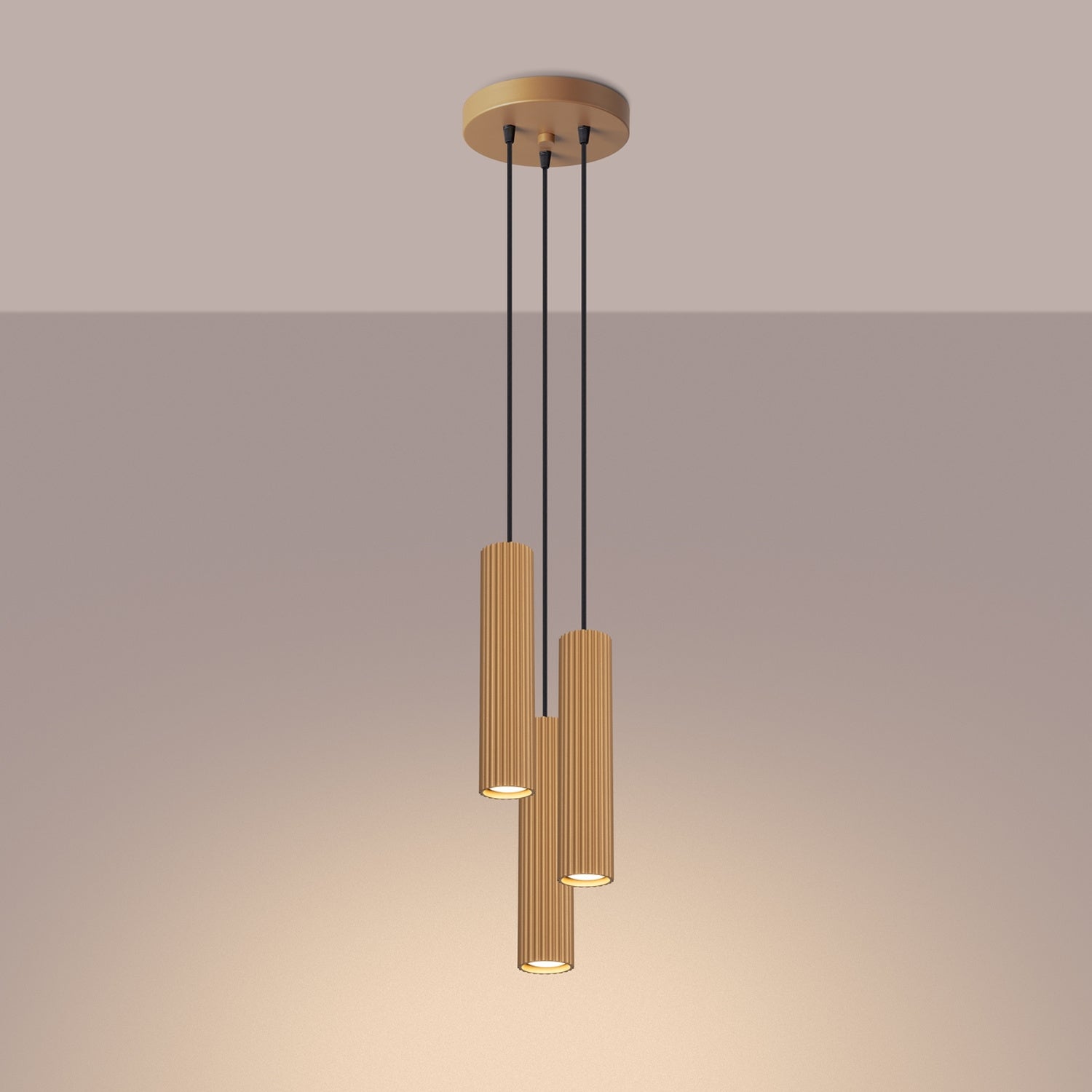 Gold Triple Ribbed Pendant Cluster switched on in modern UK home interior, warm LED glow