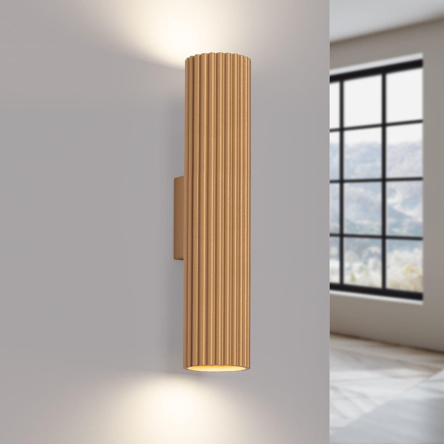 Gold Twin Ribbed Wall Light Up Down switched on in modern UK home interior, warm LED glow