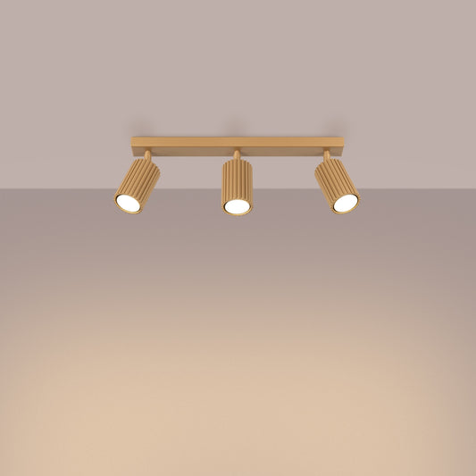 Gold Triple Ribbed Spotlight Bar switched on in modern UK home interior, warm LED glow