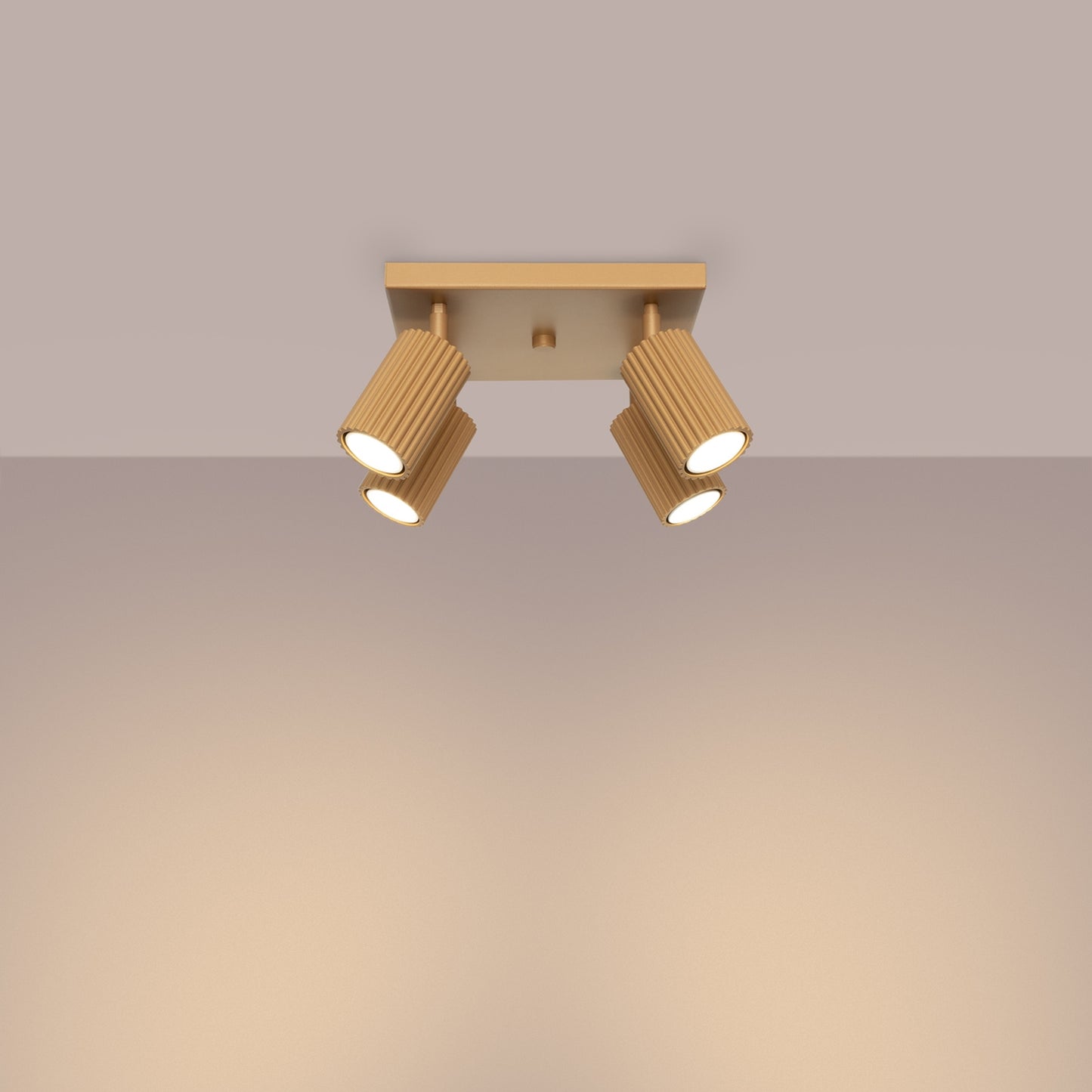 Gold Quad Ribbed Spotlight Cluster switched on in modern UK home interior, warm LED glow