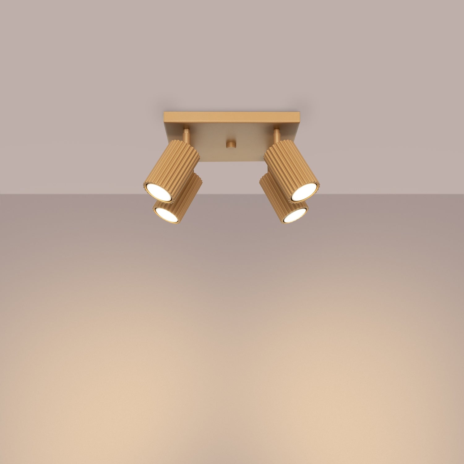 Gold Quad Ribbed Spotlight Cluster switched on in modern UK home interior, warm LED glow