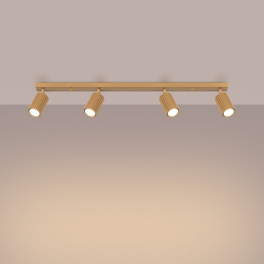 Gold Four Light Ribbed Spotlight Bar switched on in modern UK home interior, warm LED glow