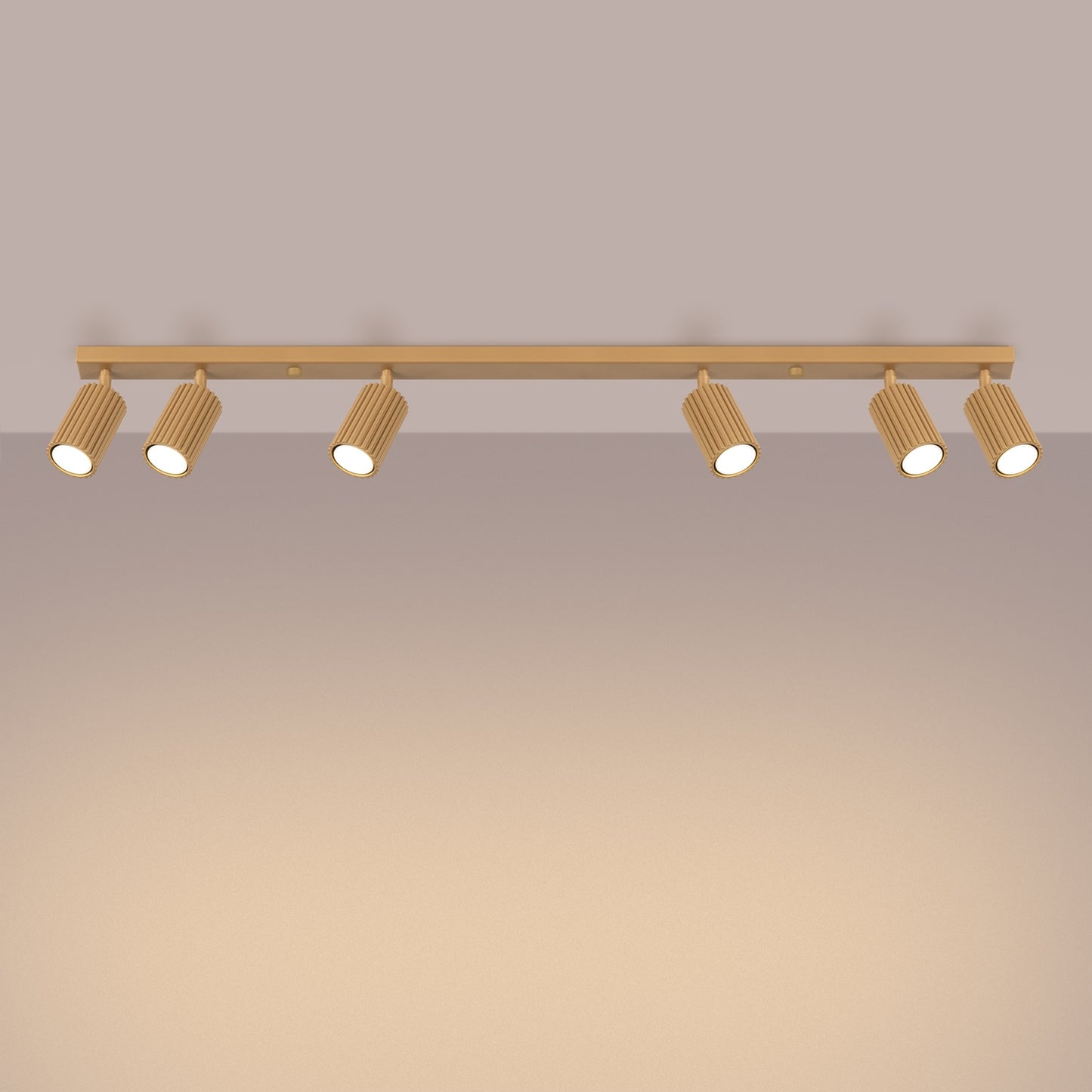 Gold Six Light Ribbed Spotlight Bar switched on in modern UK home interior, warm LED glow
