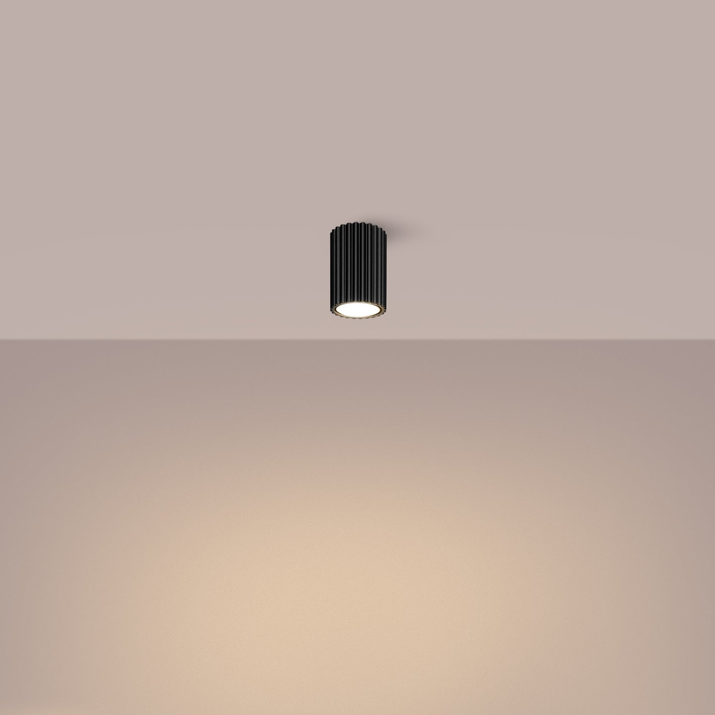 Black Ribbed Surface Spotlight switched on in modern UK home interior, warm LED glow