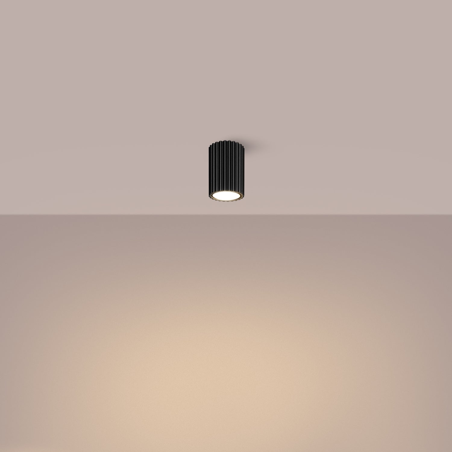 Black Ribbed Surface Spotlight switched on in modern UK home interior, warm LED glow