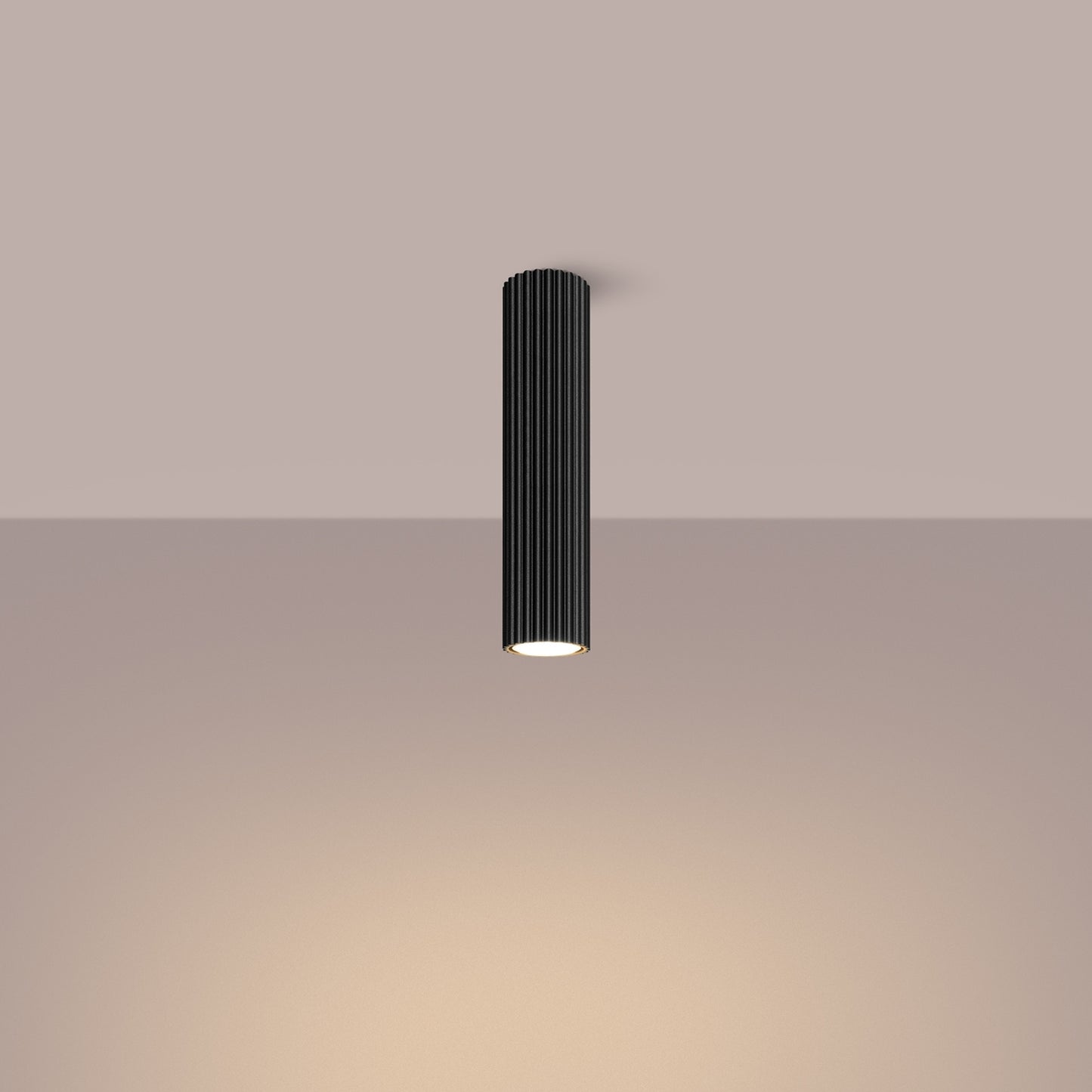 Black Tall Ribbed Cylinder Ceiling Spotlight switched on in modern UK home interior, warm LED glow