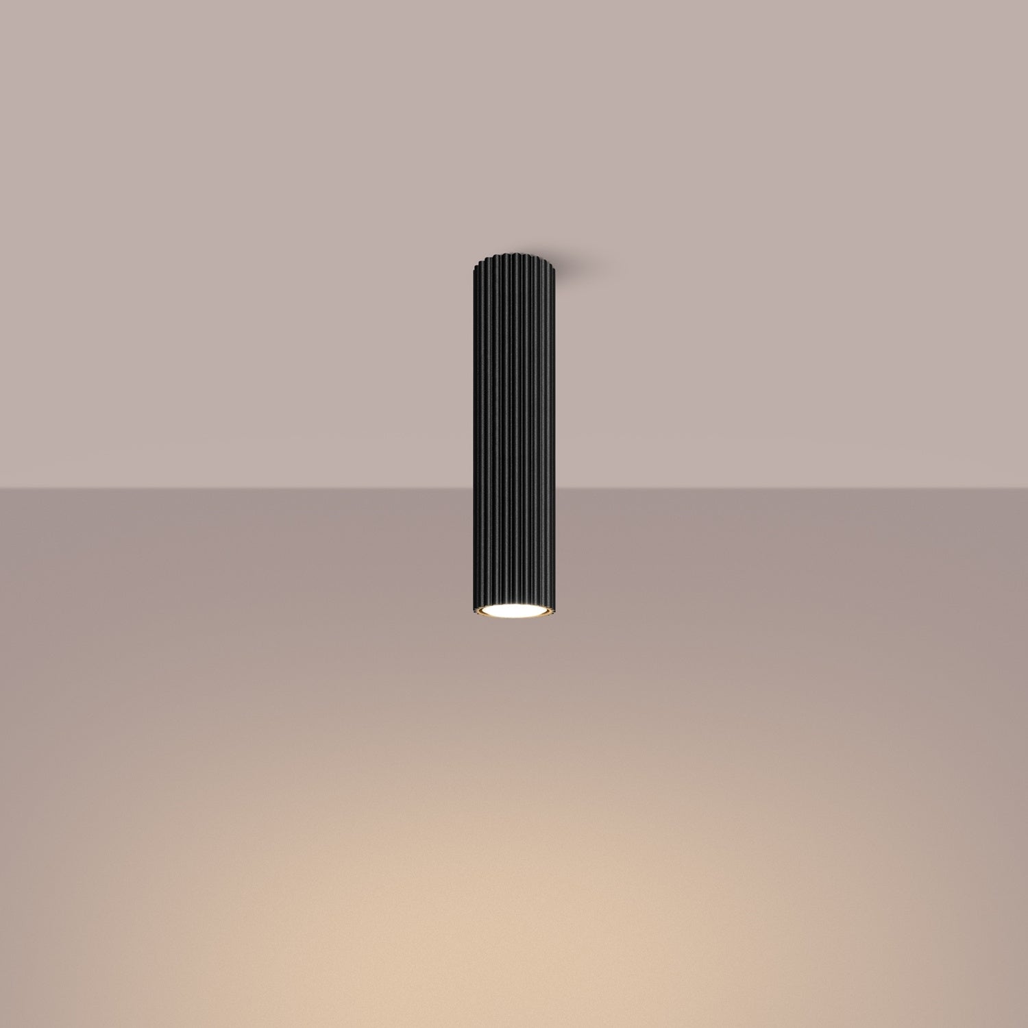 Black Tall Ribbed Cylinder Ceiling Spotlight switched on in modern UK home interior, warm LED glow