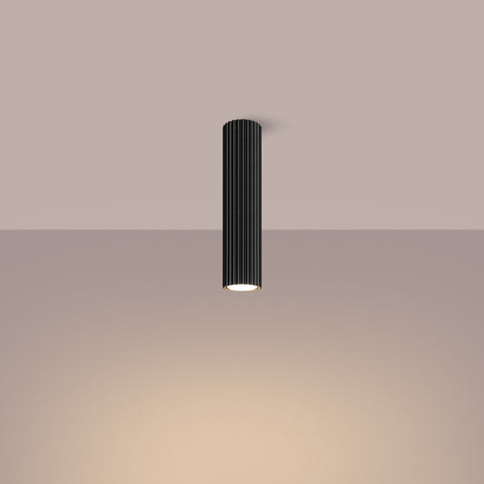 Black Tall Ribbed Cylinder Ceiling Spotlight switched on in modern UK home interior, warm LED glow