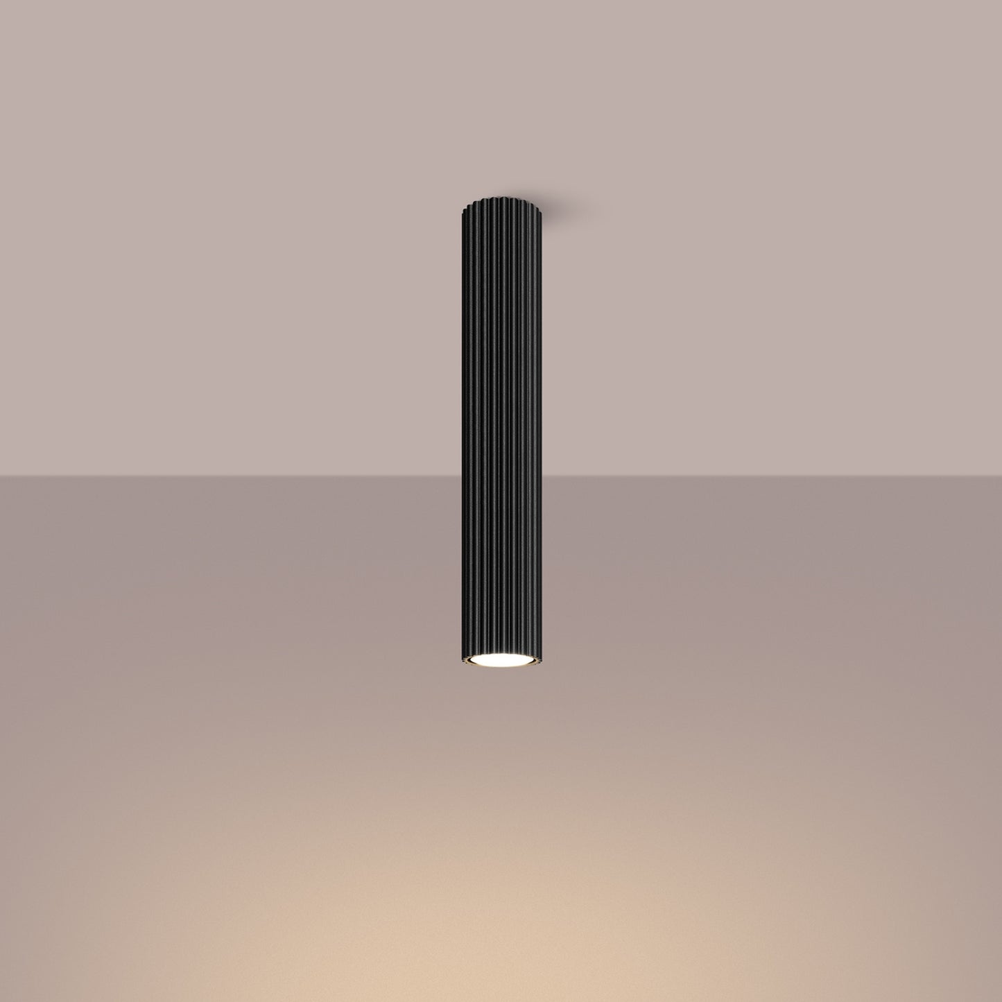 Black Extra Tall Ribbed Cylinder Ceiling Light switched on in modern UK home interior, warm LED glow