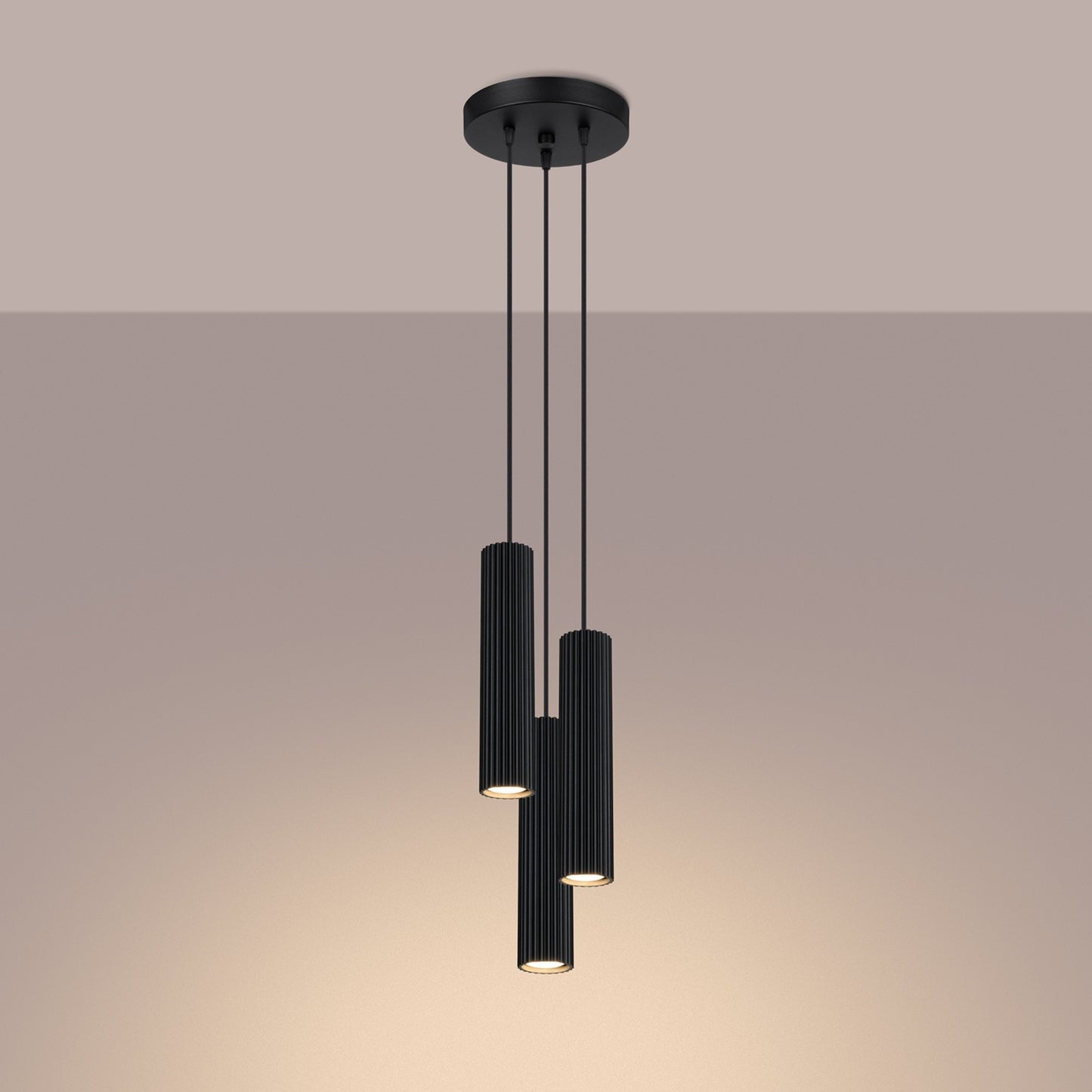Black Triple Ribbed Pendant Cluster switched on in modern UK home interior, warm LED glow
