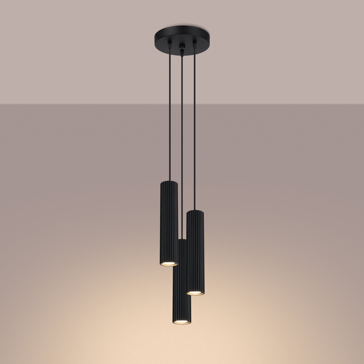 Black Triple Ribbed Pendant Cluster switched on in modern UK home interior, warm LED glow