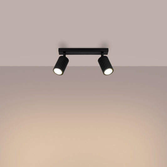 Black Twin Ribbed Surface Spotlight switched on in modern UK home interior, warm LED glow