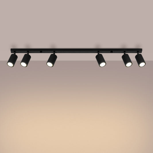 Black Six Light Ribbed Spotlight Bar switched on in modern UK home interior, warm LED glow