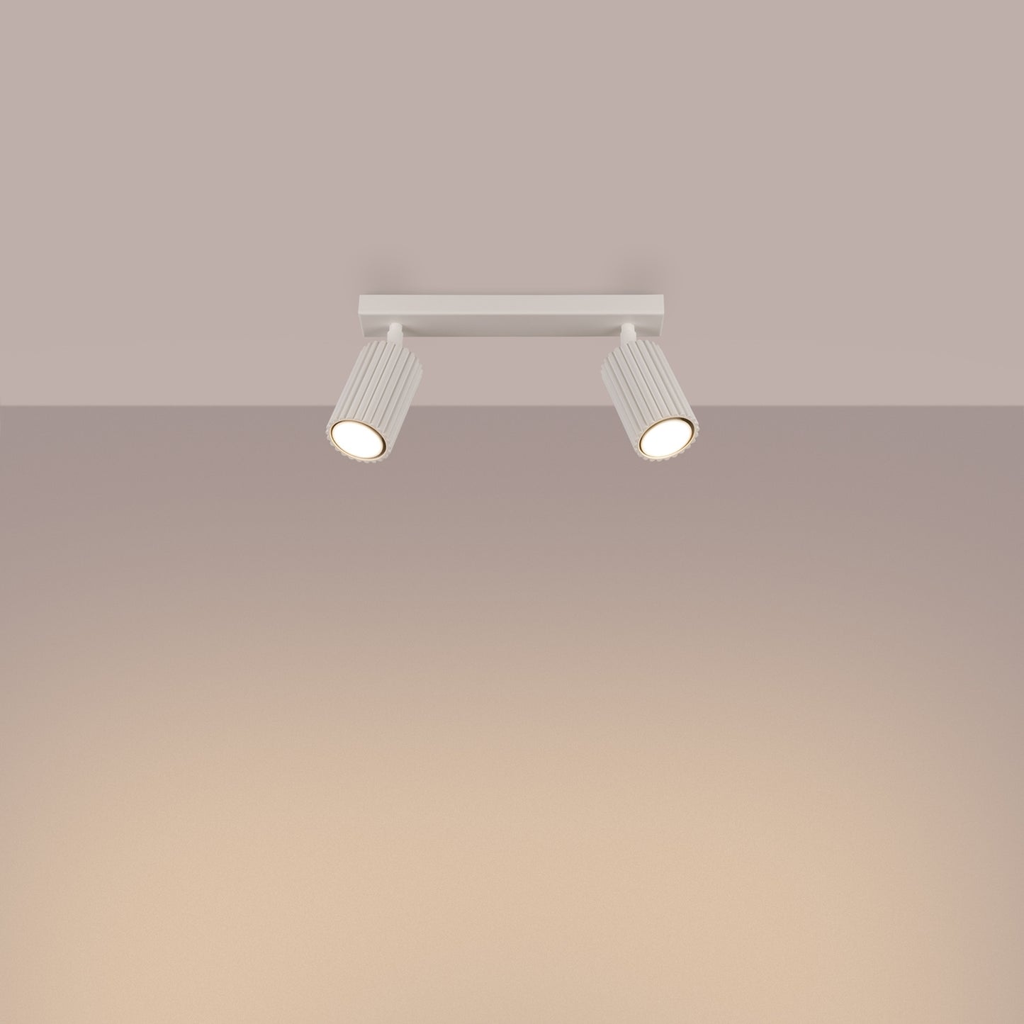 Beige Twin Ribbed Surface Spotlight switched on in modern UK home interior, warm LED glow