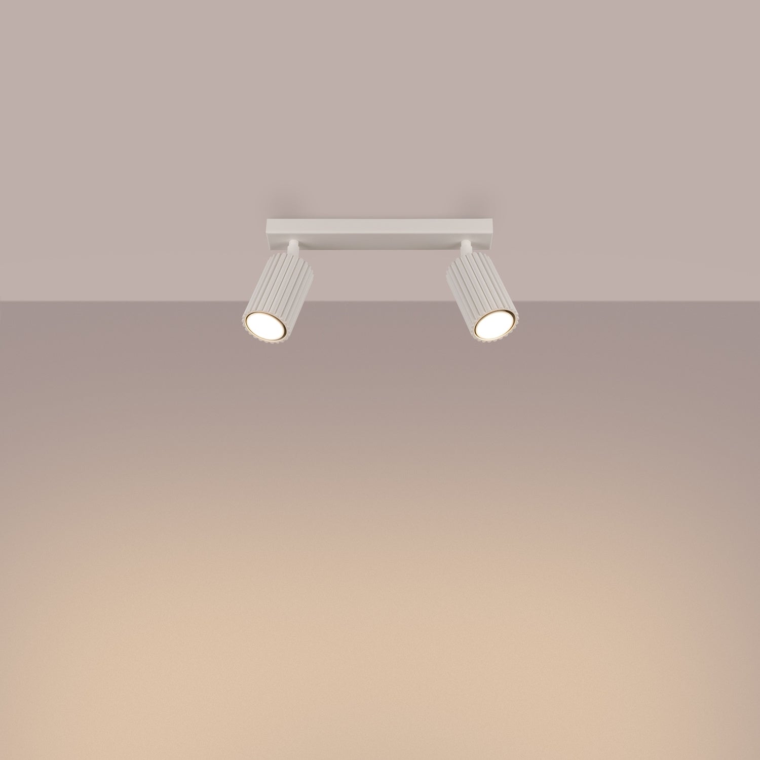 Beige Twin Ribbed Surface Spotlight switched on in modern UK home interior, warm LED glow