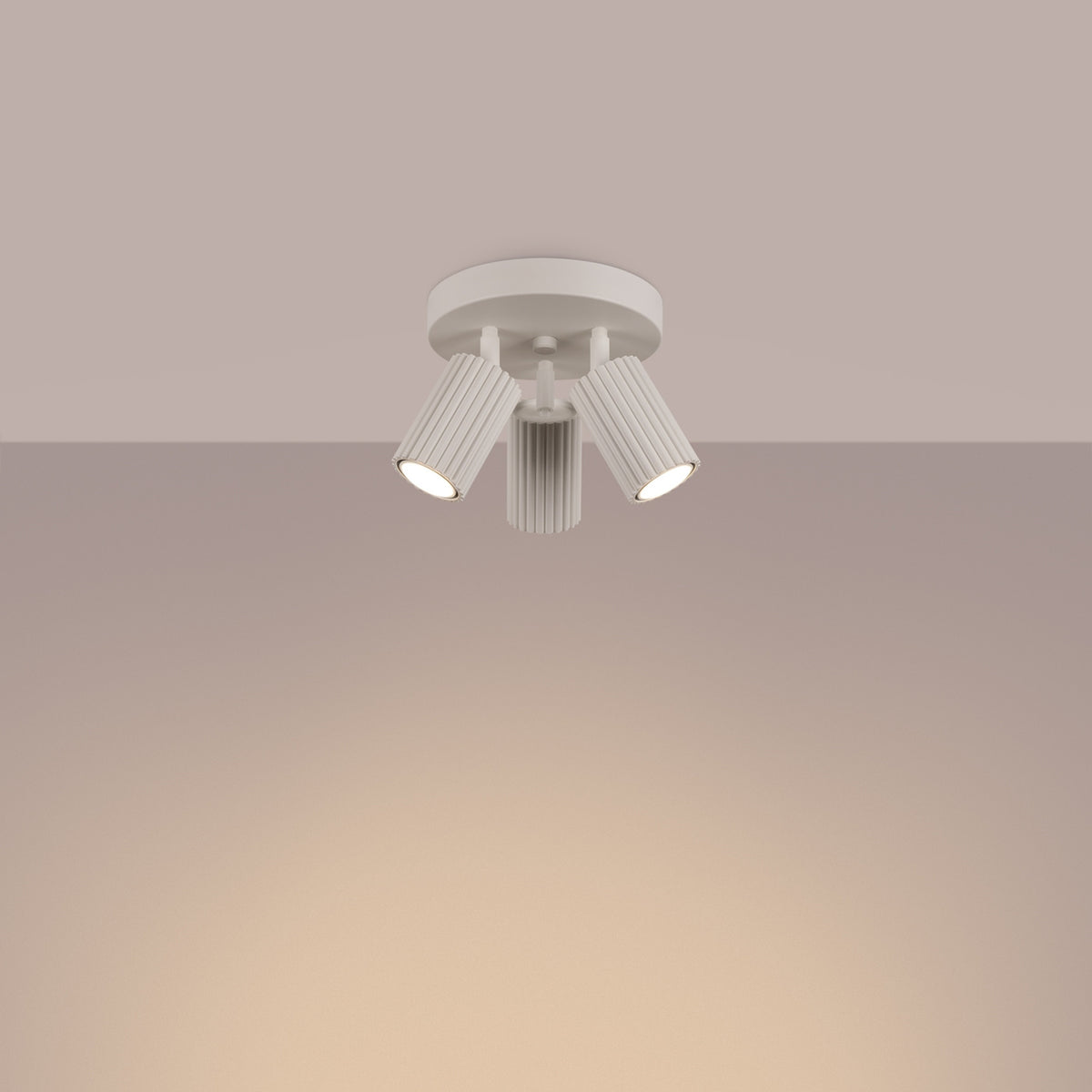 Beige Triple Ribbed Spotlight Cluster switched on in modern UK home interior, warm LED glow