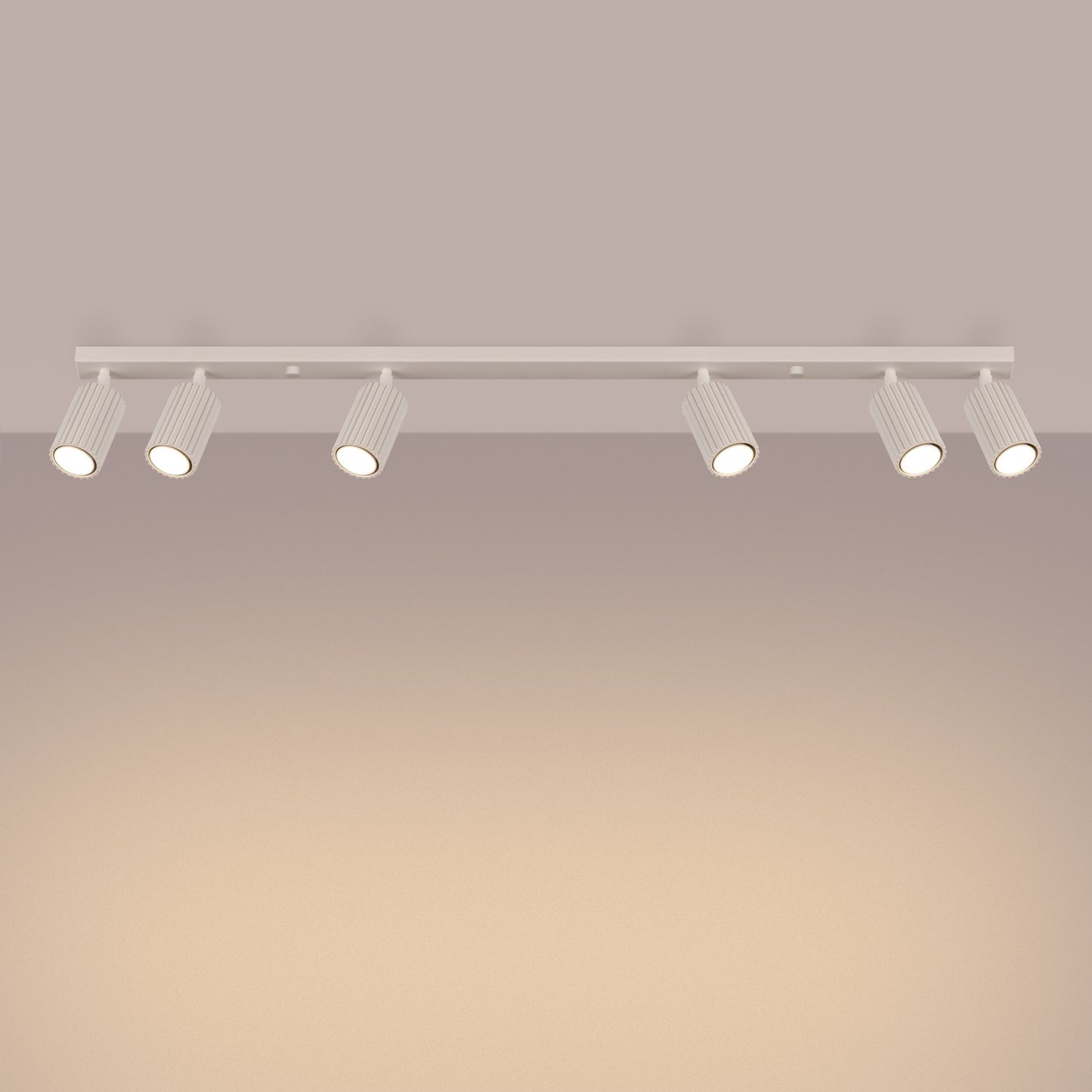 Beige Six Light Ribbed Spotlight Bar switched on in modern UK home interior, warm LED glow