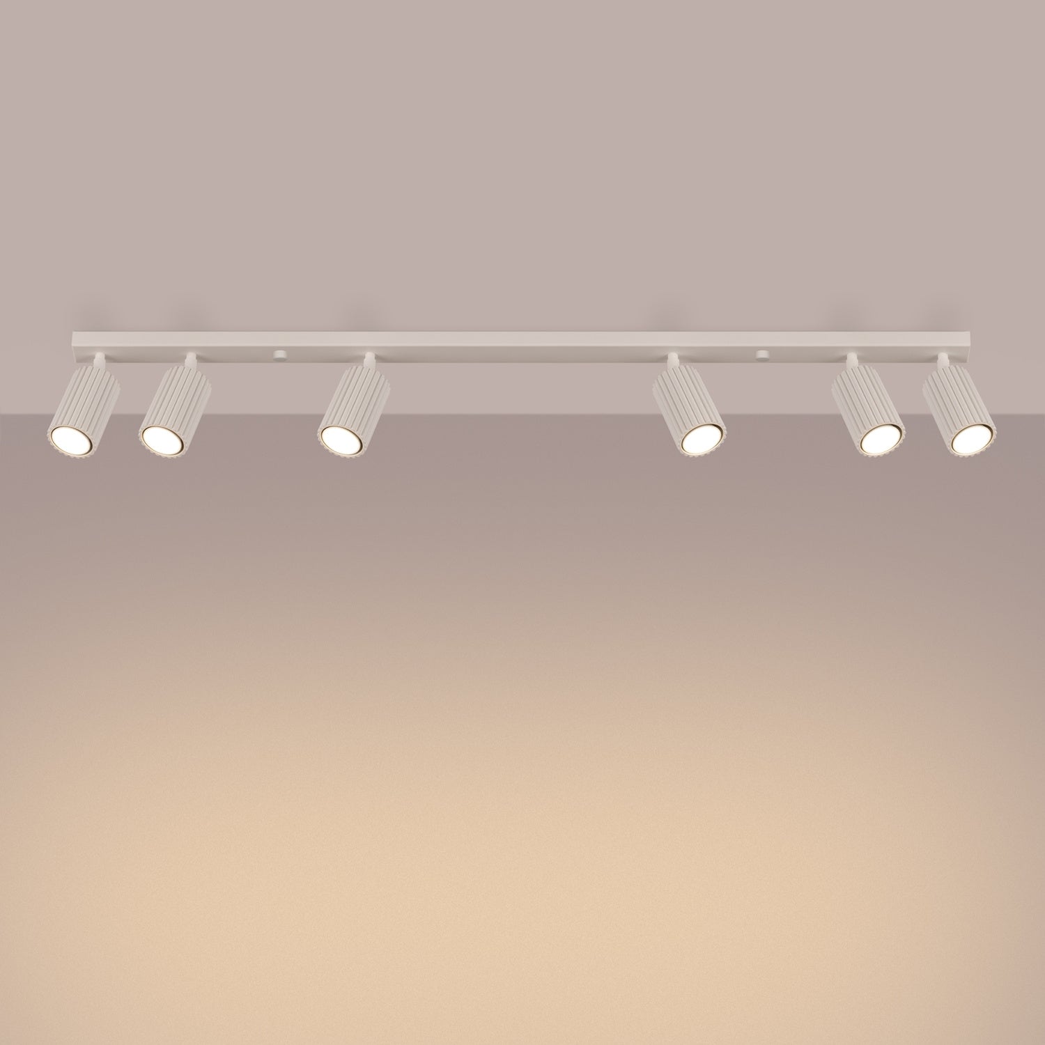 Beige Six Light Ribbed Spotlight Bar switched on in modern UK home interior, warm LED glow