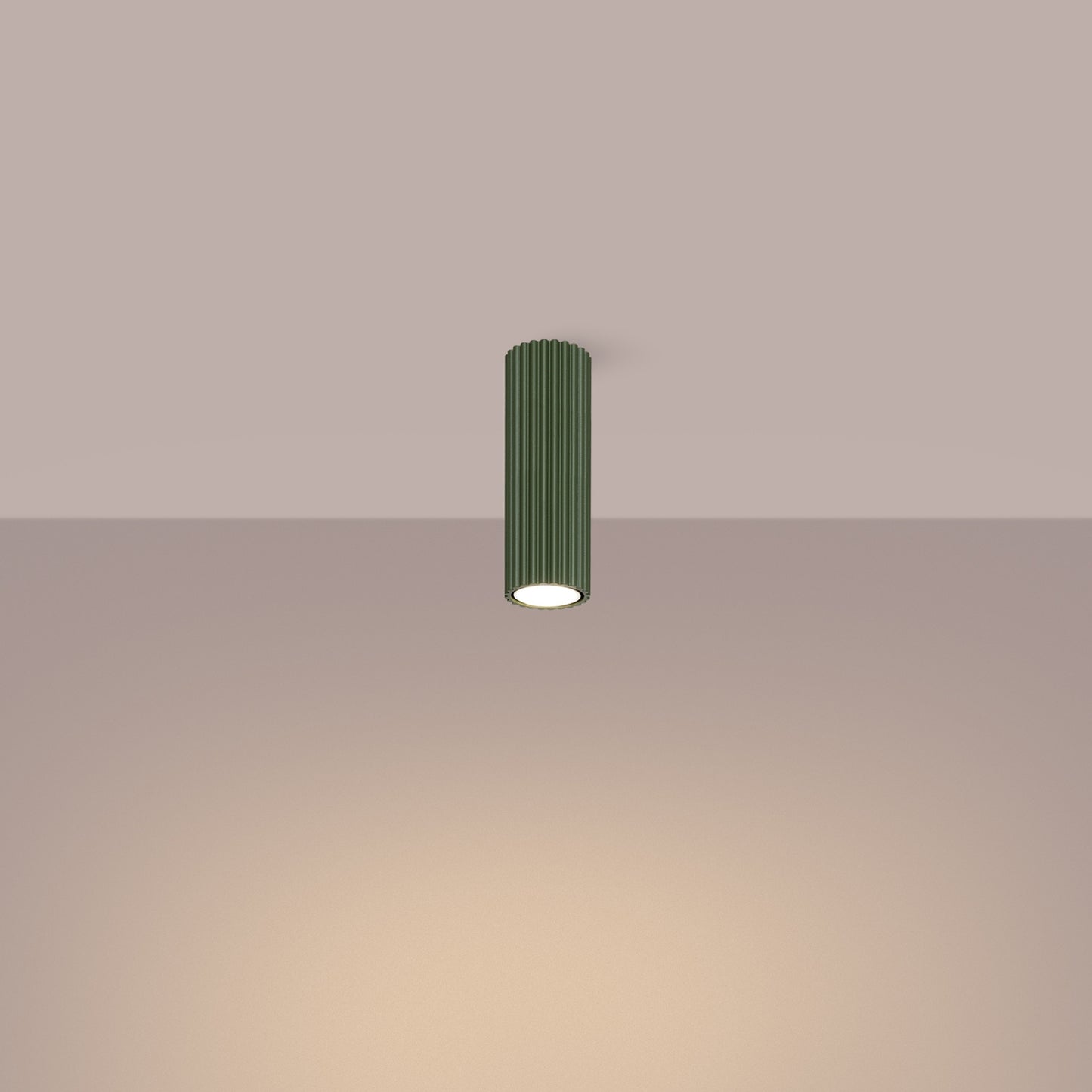 Olive Green Ribbed Tube Ceiling Spotlight 20cm switched on in modern UK home interior, warm LED glow