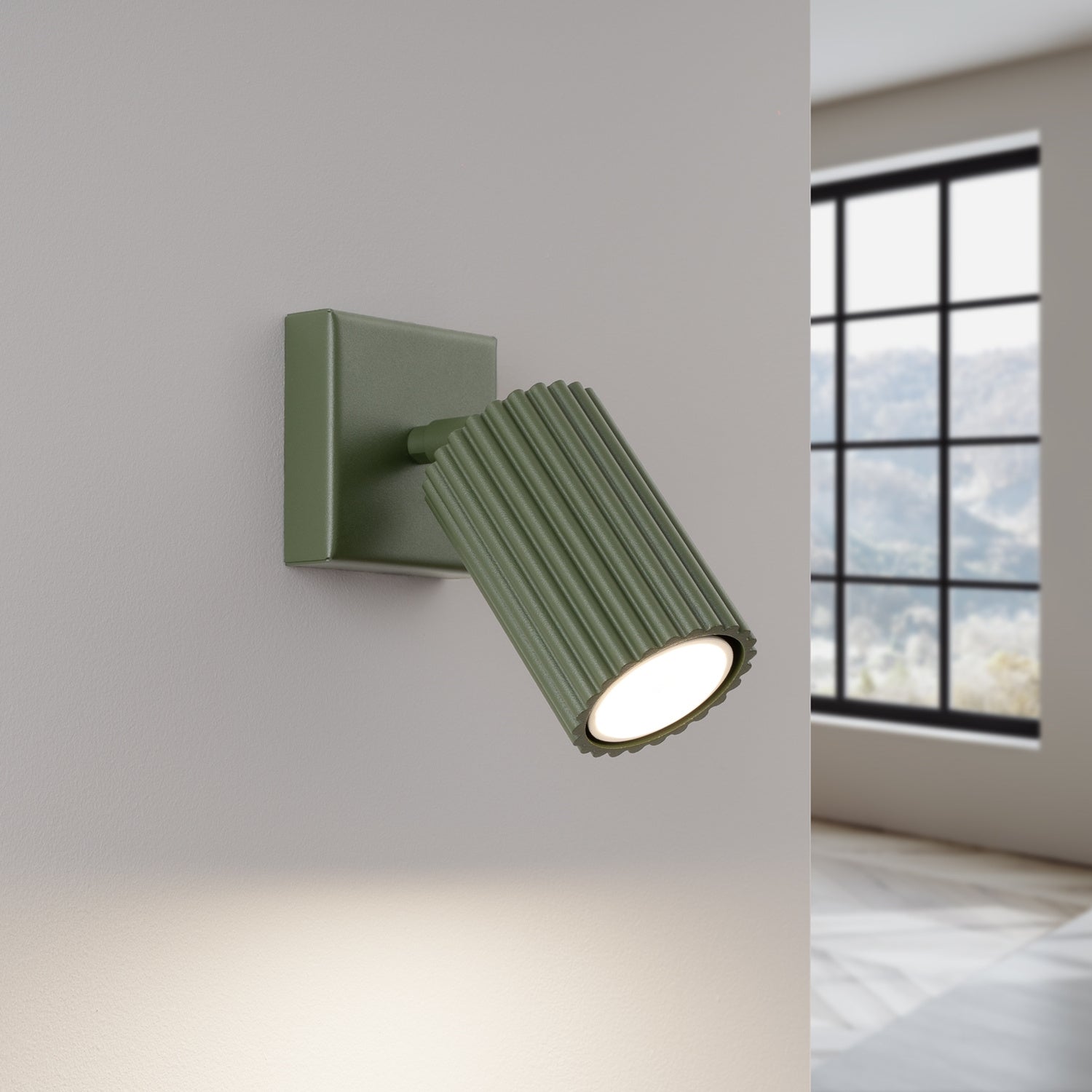 Olive Green Ribbed Tube Wall Light switched on in modern UK home interior, warm LED glow