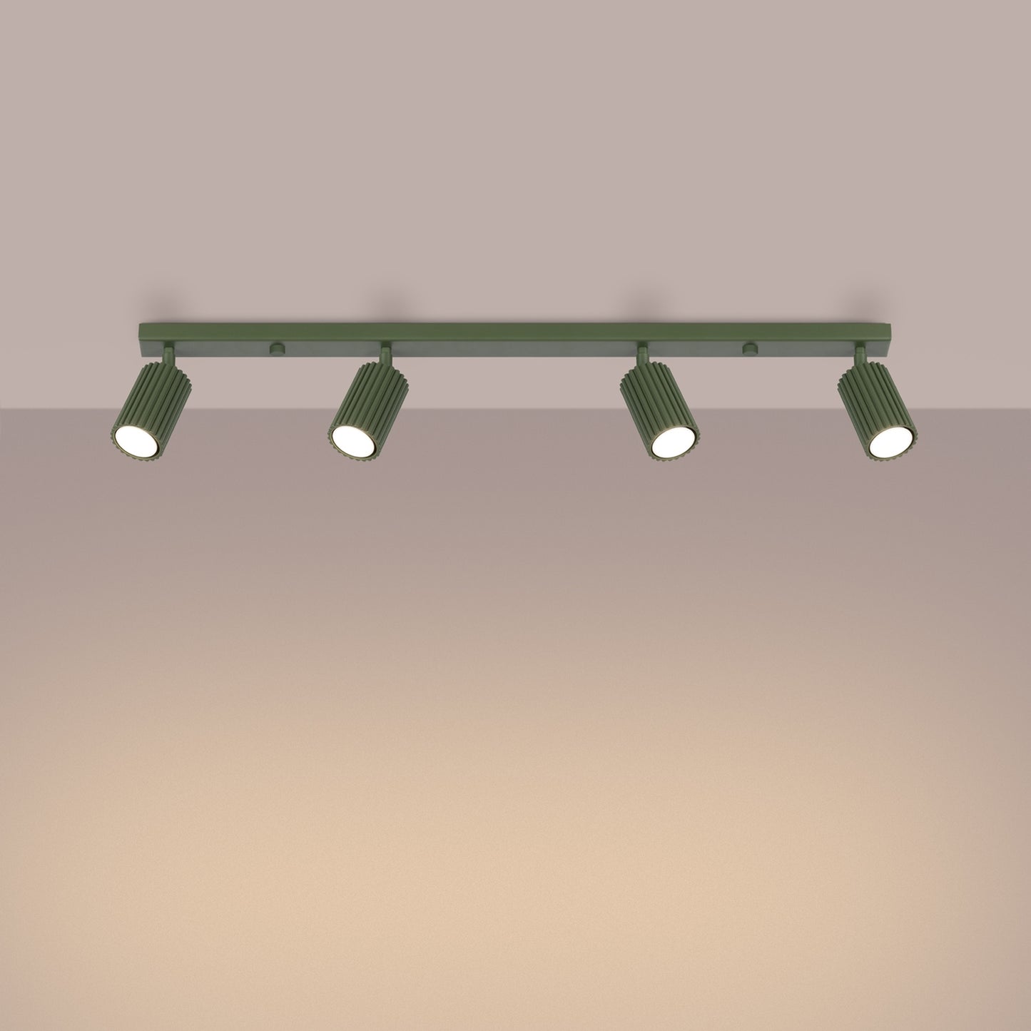 Olive Green Four Light Ribbed Spotlight Bar switched on in modern UK home interior, warm LED glow