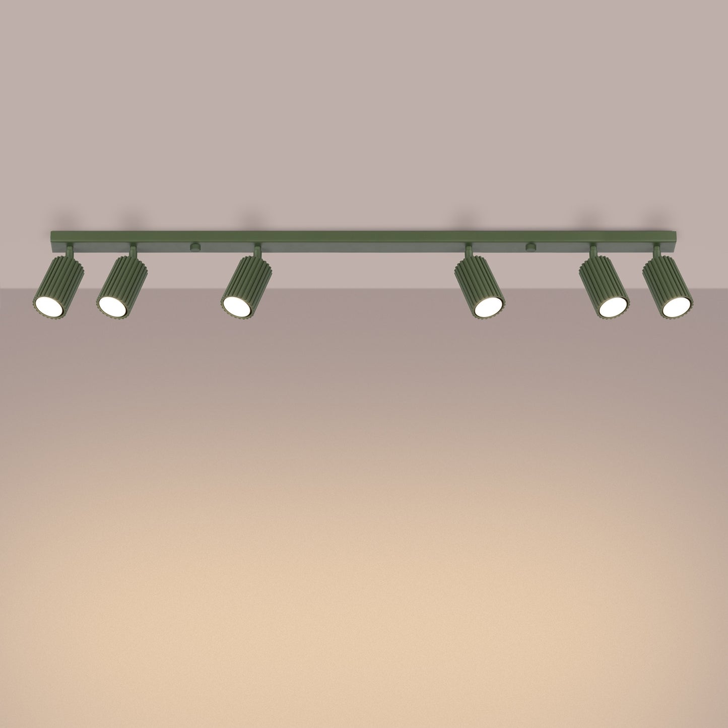 Olive Green Six Light Ribbed Spotlight Bar switched on in modern UK home interior, warm LED glow
