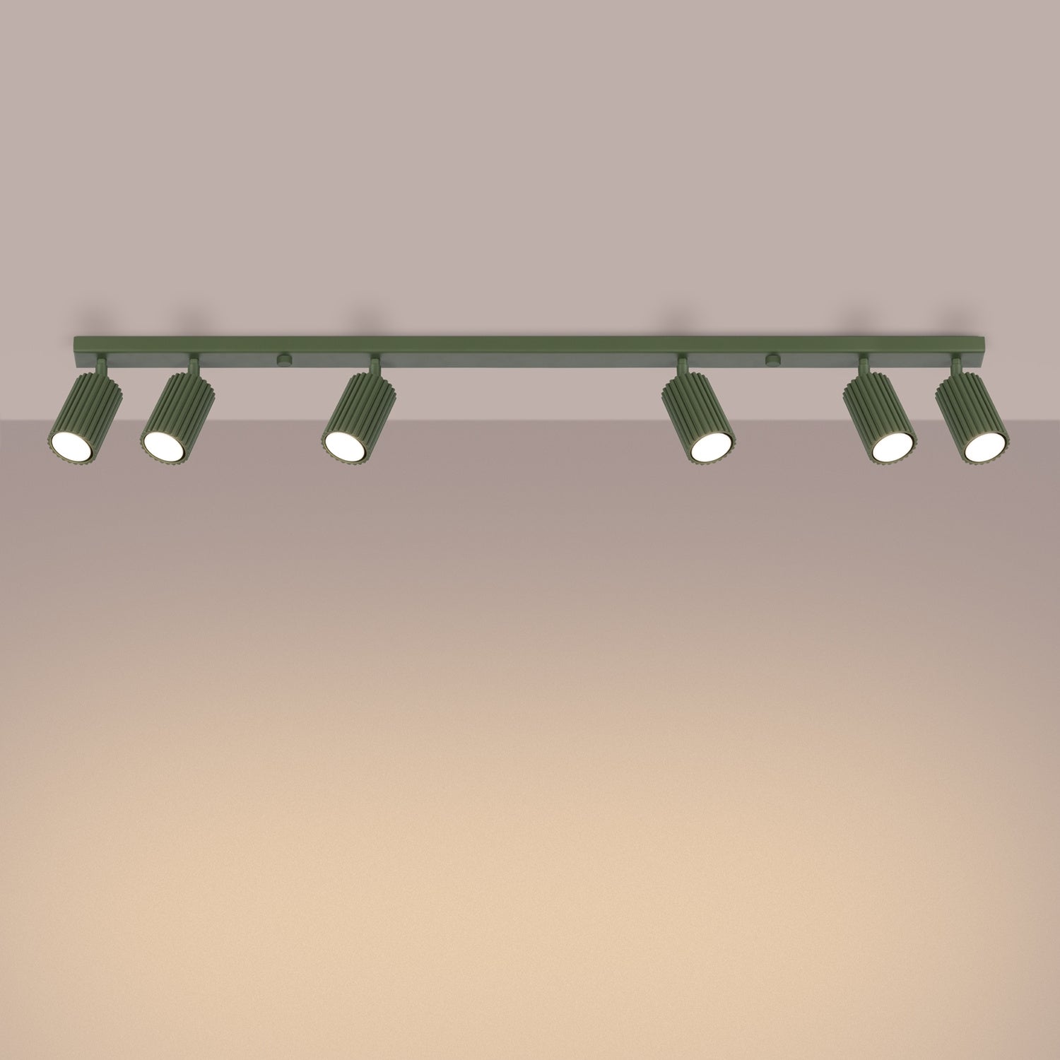Olive Green Six Light Ribbed Spotlight Bar switched on in modern UK home interior, warm LED glow