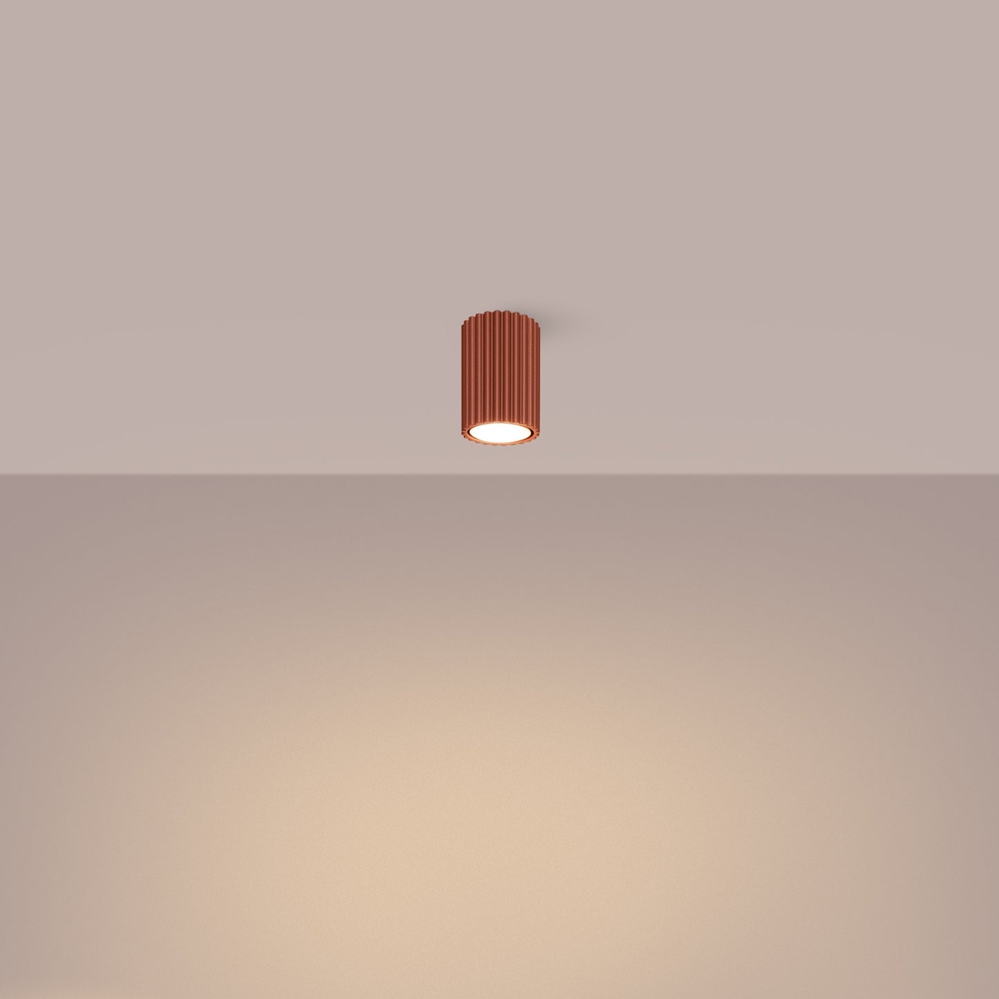 Red Ochre Ribbed Surface Spotlight switched on in modern UK home interior, warm LED glow